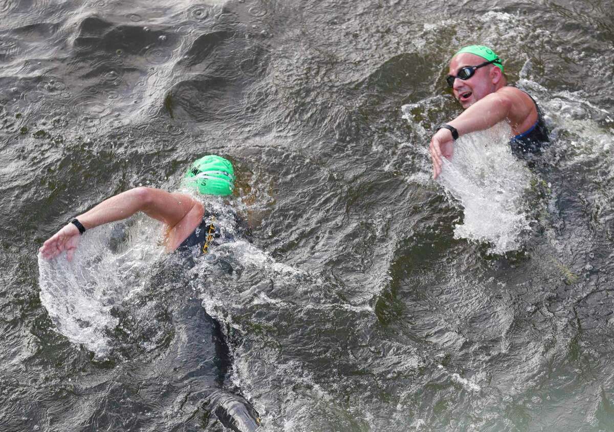 Triathletes compete in the swimming portion of the Ironman Triathlon, Saturday, April 23, 2022, in The Woodlands.