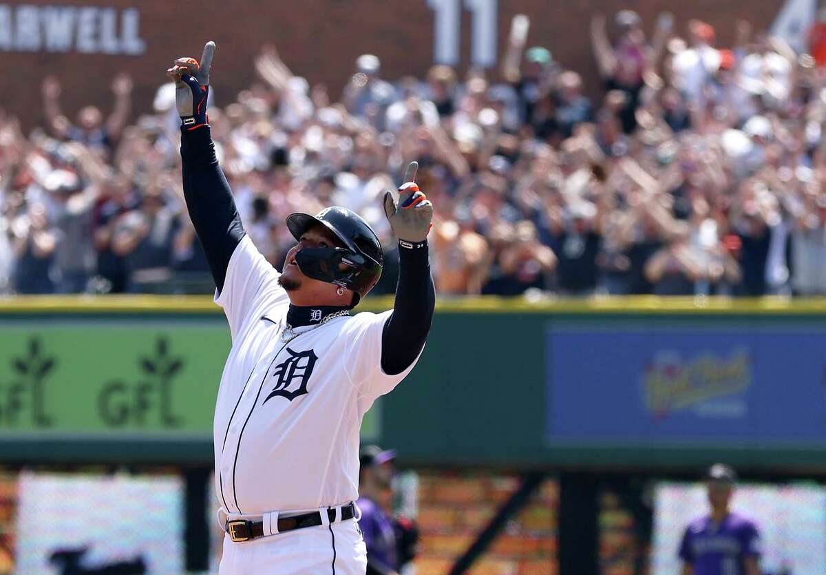 Above, Miguel Cabrera celebrates Saturday after hitting a first-inning single against the Rockies, his 3,000th hit. His home run and hit totals are tracked at Comerica Park, below.