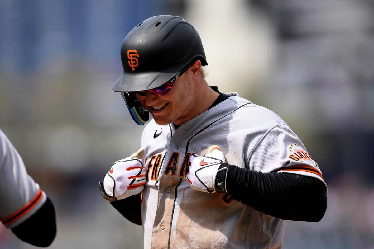 San Francisco Giants' Joc Pederson gestures at first base after he singled in a run during the fifth inning of a baseball game against the Washington Nationals, Saturday, April 23, 2022, in Washington. Austin Slater scored on the play. (AP Photo/Nick Wass)