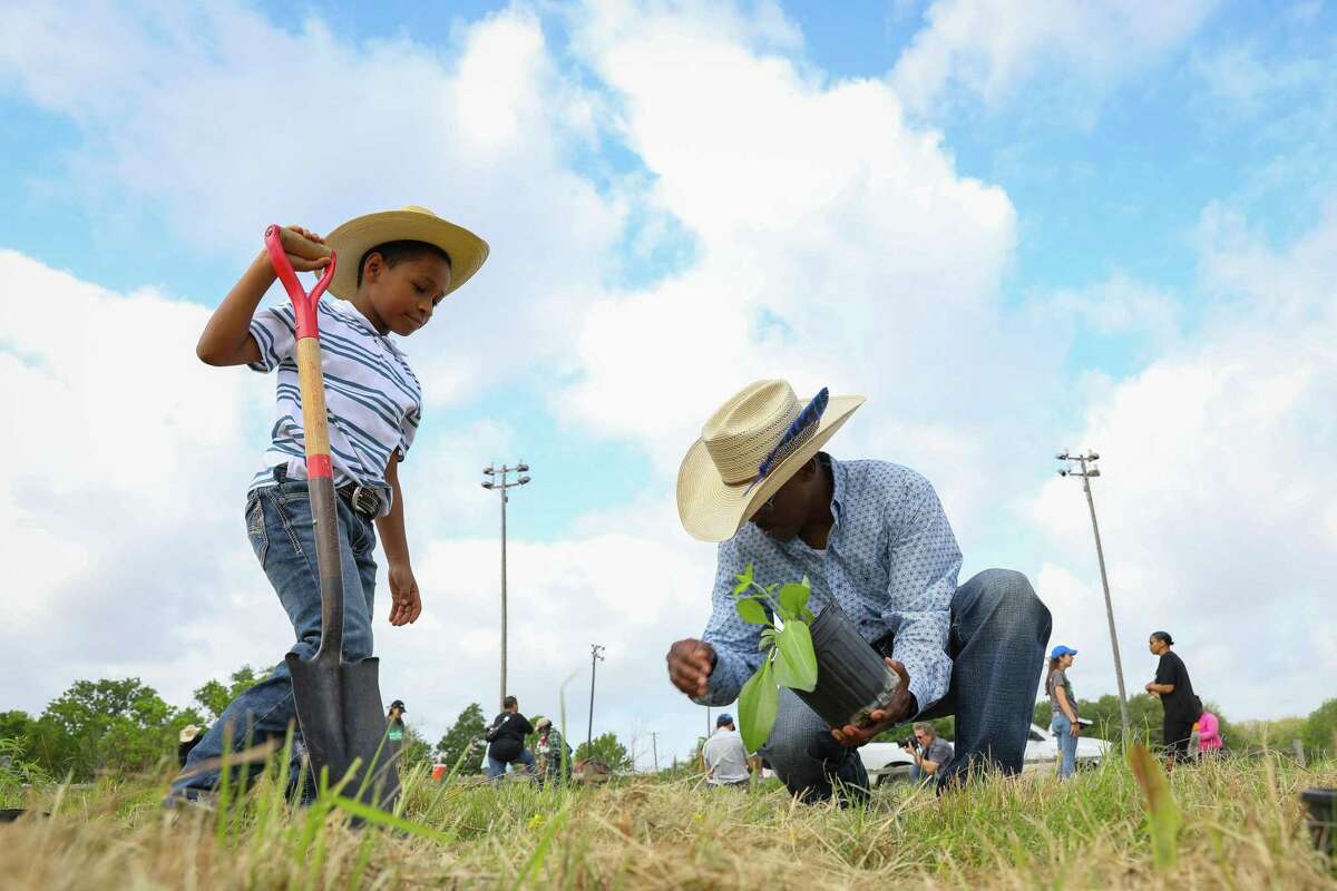 Eight-year-old Colten Littles helps Desmond Trotter plant prairie plants, Saturday, April 23, 2022, at Clinton Park in Houston. The members of the Acres Homes Riding and Roping Club were invited to the event to share the legacy of Black cowboys. The event planting prairie grasses provided by the City of Houston Parks and Recreation Department is part of program sponsored by The Nature Conservancy called the Witness Series which, inspired by work by artist Kristi Rangel, seeks to explore the connections between African American communities and the land in Southeast Texas.