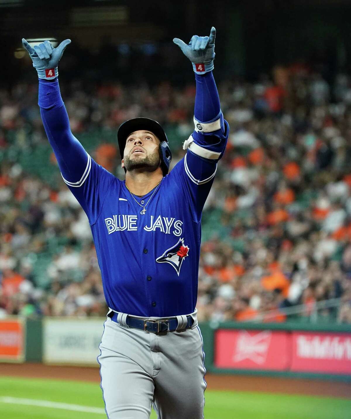 Toronto Blue Jays designated hitter George Springer (4) celebrates after hitting a solo home run against the Houston Astros during the first inning of an MLB game at Minute Maid Park on Saturday, April 23, 2022, in Houston.
