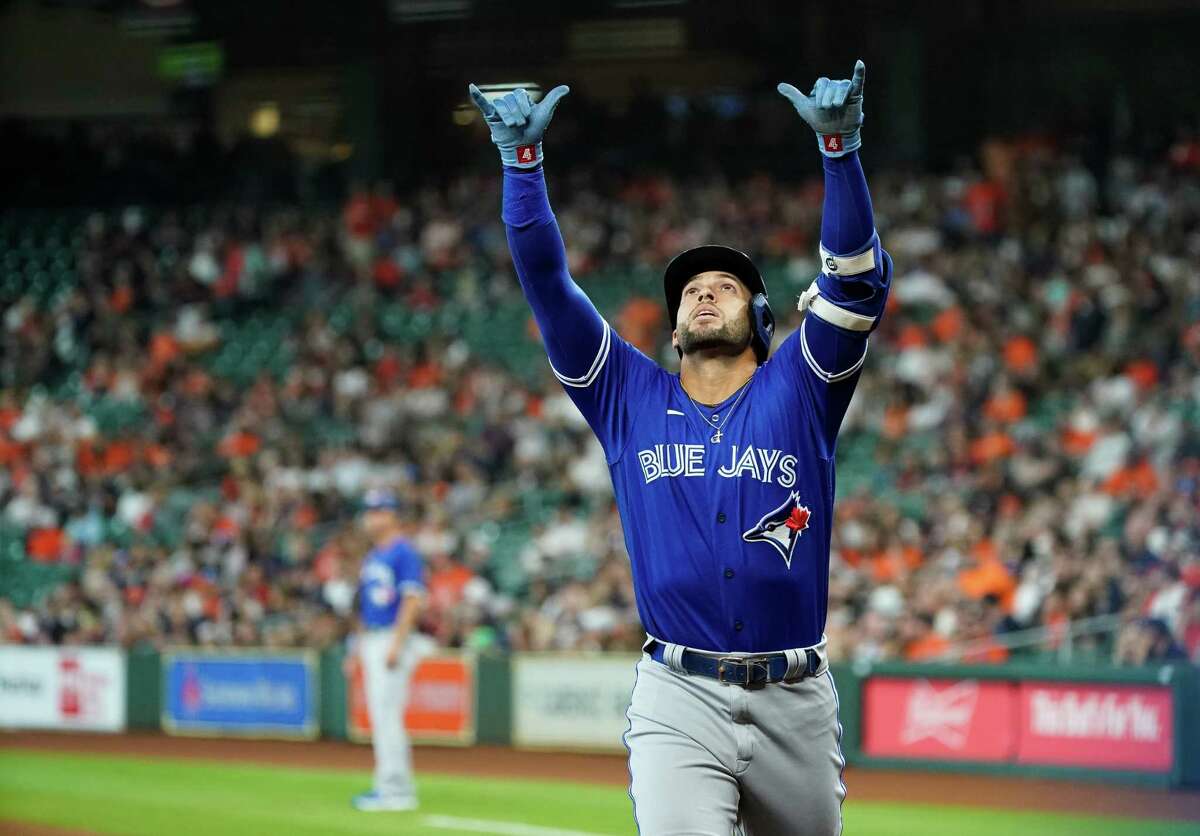 Toronto Blue Jays designated hitter George Springer (4) celebrates after hitting a solo home run against the Houston Astros during the first inning of an MLB game at Minute Maid Park on Saturday, April 23, 2022, in Houston.