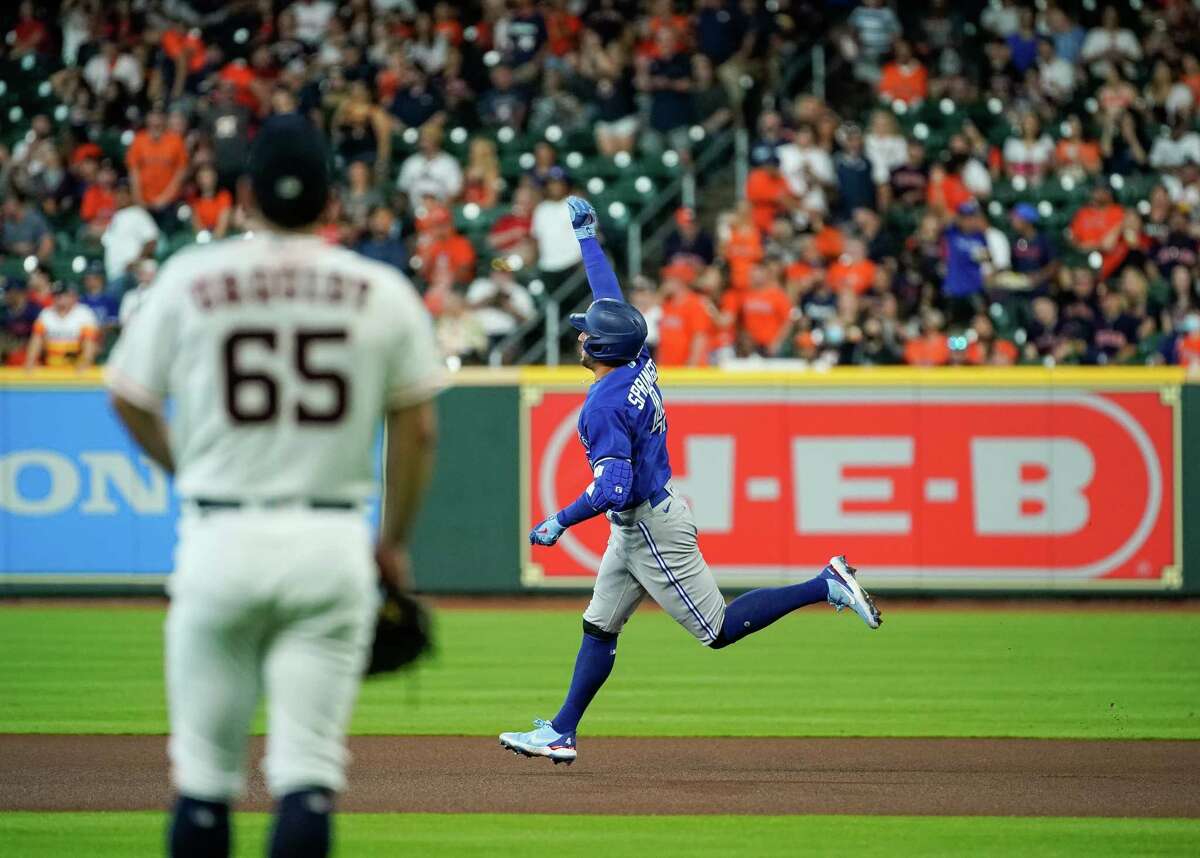 Toronto Blue Jays designated hitter George Springer (4) rounds the bases after hitting a solo home run against the Houston Astros during the first inning of an MLB game at Minute Maid Park on Saturday, April 23, 2022, in Houston.