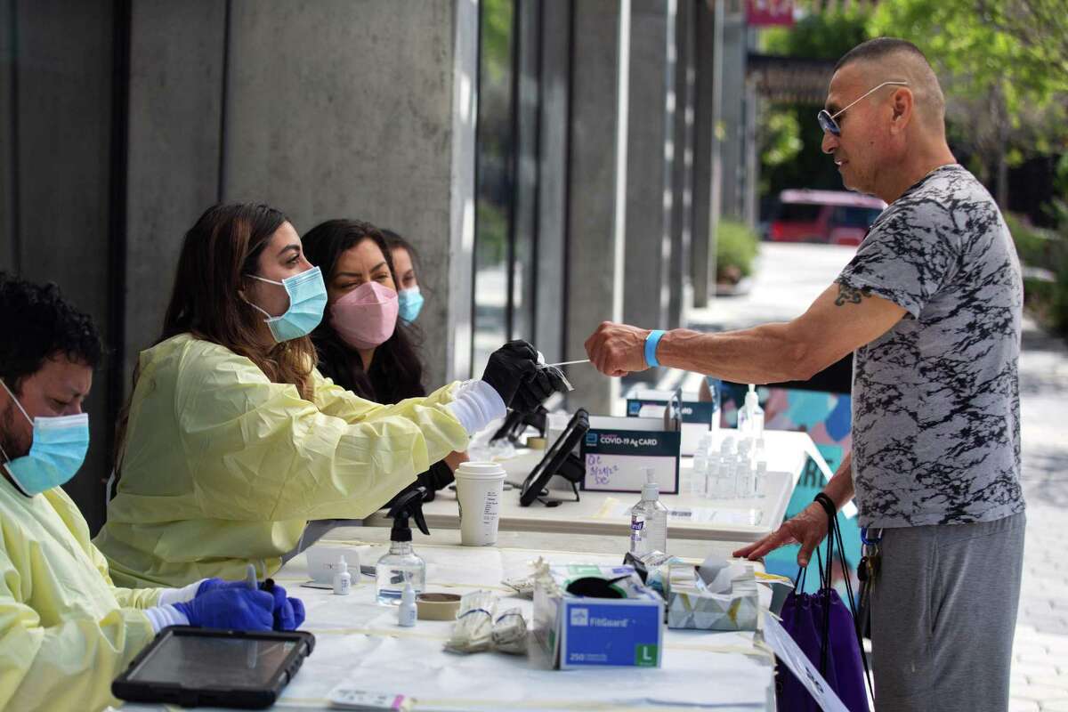 Jose Contreras of San Francisco gets a COVID test, assisted by test administrators from Safer Together, during the “Vidas Saludables” Community Health and Wealth Fair in San Francisco on April 23.