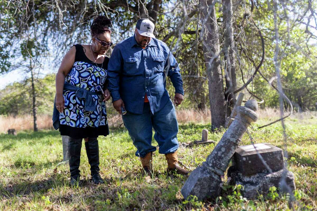 Lola Kelly Wilcox Moore and Mar’lon Wilcox Moore look over an aged headstone at Ridley Cemetery in Seguin on April 7. The family is preserving the cemetery and their family’s Wilcox Ranch, the oldest and last African American working ranch in Jakes Colony, a Freedman’s Colony in the area.
