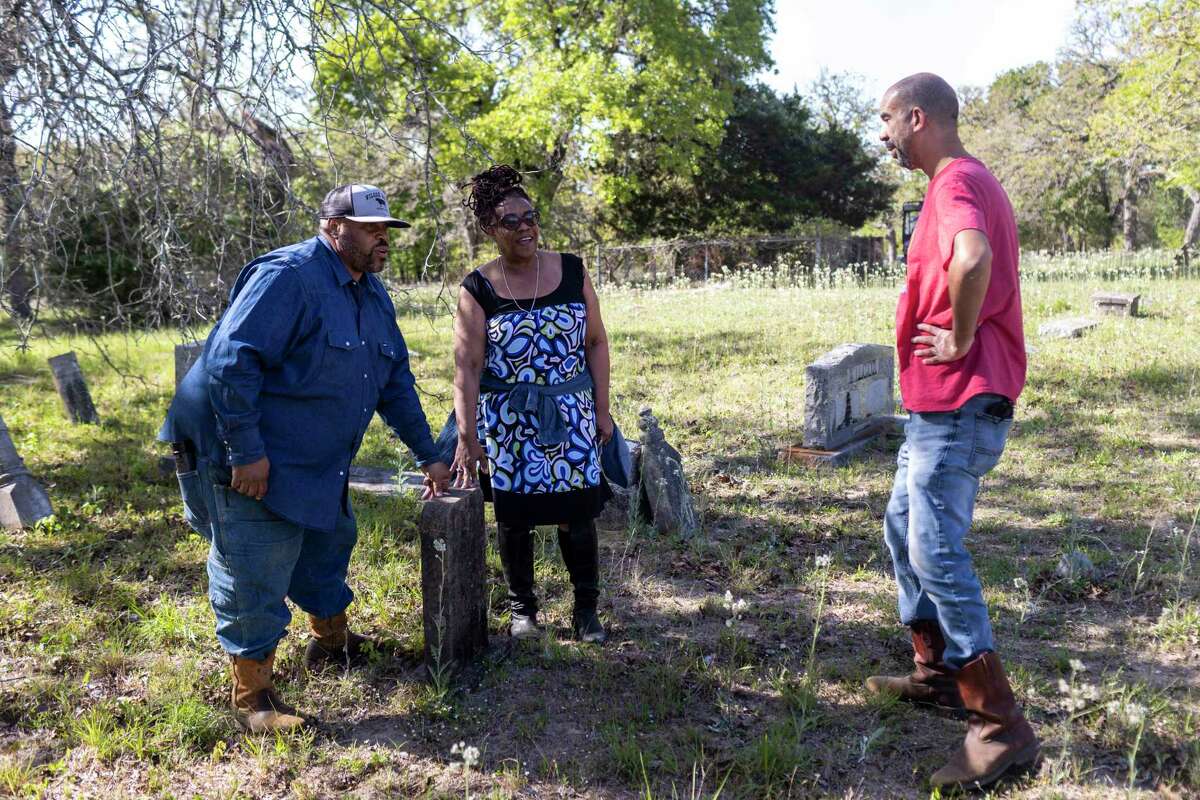 Mar’lon Wilcox Moore, Lola Kelly Wilcox Moore, and Malcolm Moore talk together at Ridley Cemetery in Seguin on April 7. The family is preserving the Wilcox Ranch, the oldest and last African American working ranch in Jakes Colony, a Freedman’s Colony in the area.