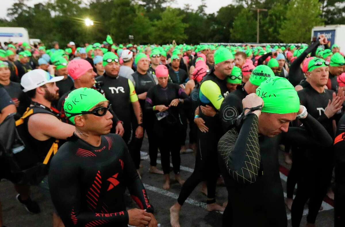 Triathletes wait to compete in the swimming portion of the Ironman Triathlon, Saturday, April 23, 2022, in The Woodlands.