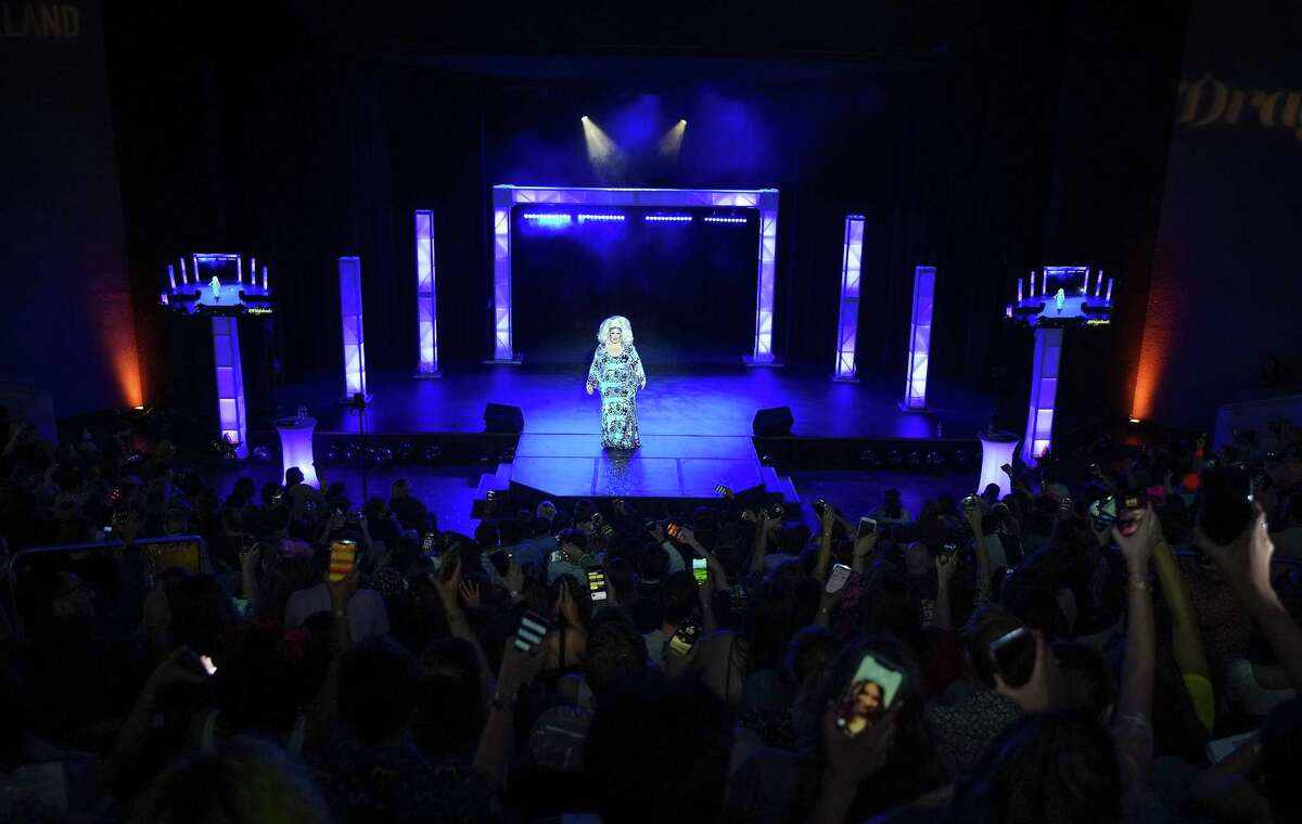 A sold-out audience gives some light as Queen of Draggieland 2021 Cora Cadette gives a final performance with Whitney Houston mash up during Draggieland at Rudder Theatre at Texas A&M on Monday, April 18, 2022.