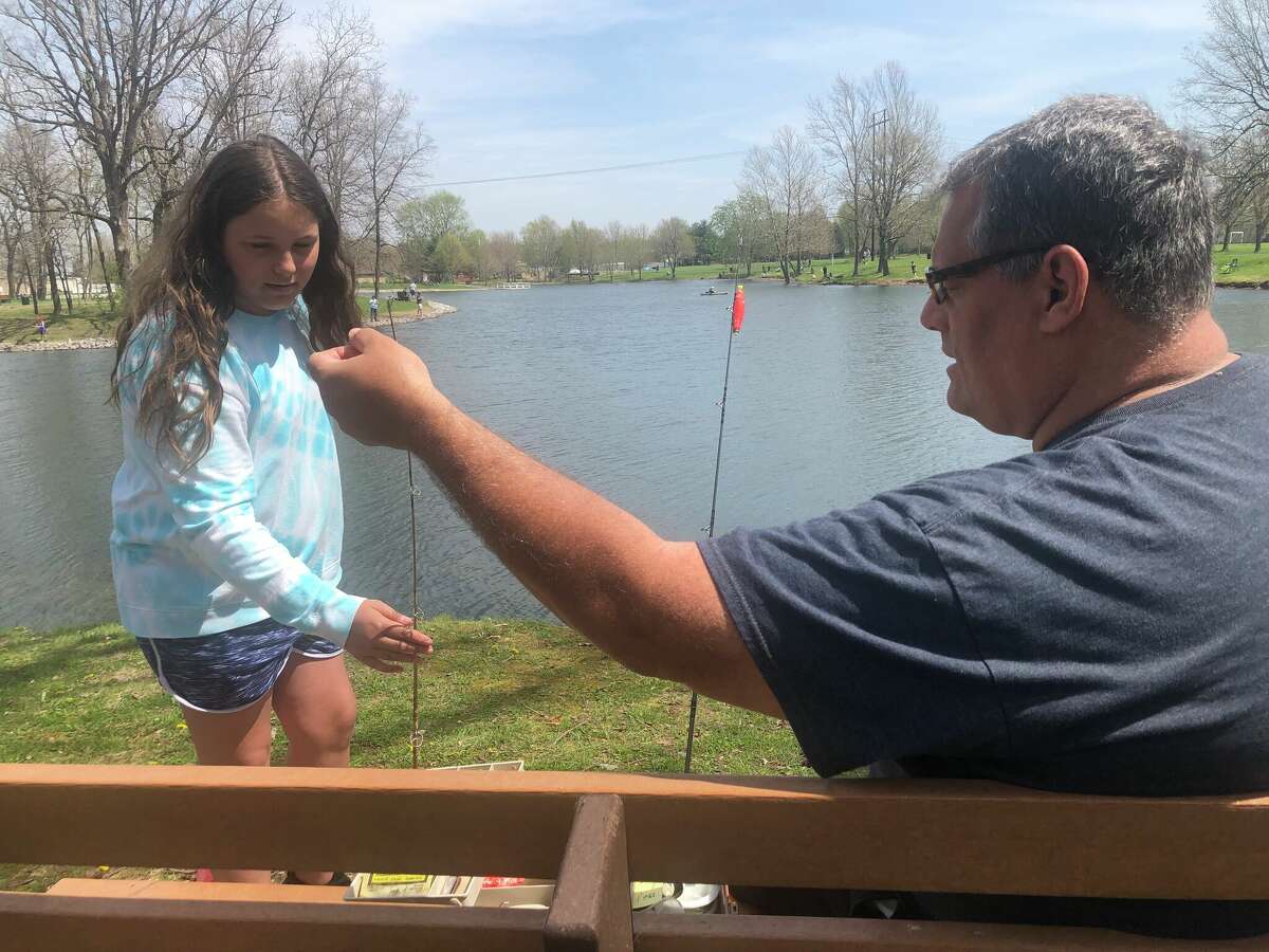 Ava works with her dad, Mike, to prepare her fishing pole and line, using a worm for bait. Dozens of other youngsters attended the derby as well, which was presented by Maryville Parks and Recreation Committee and Steel City Bassmasters. Ribbons and prizes were awarded to winners for their catches of the day. 