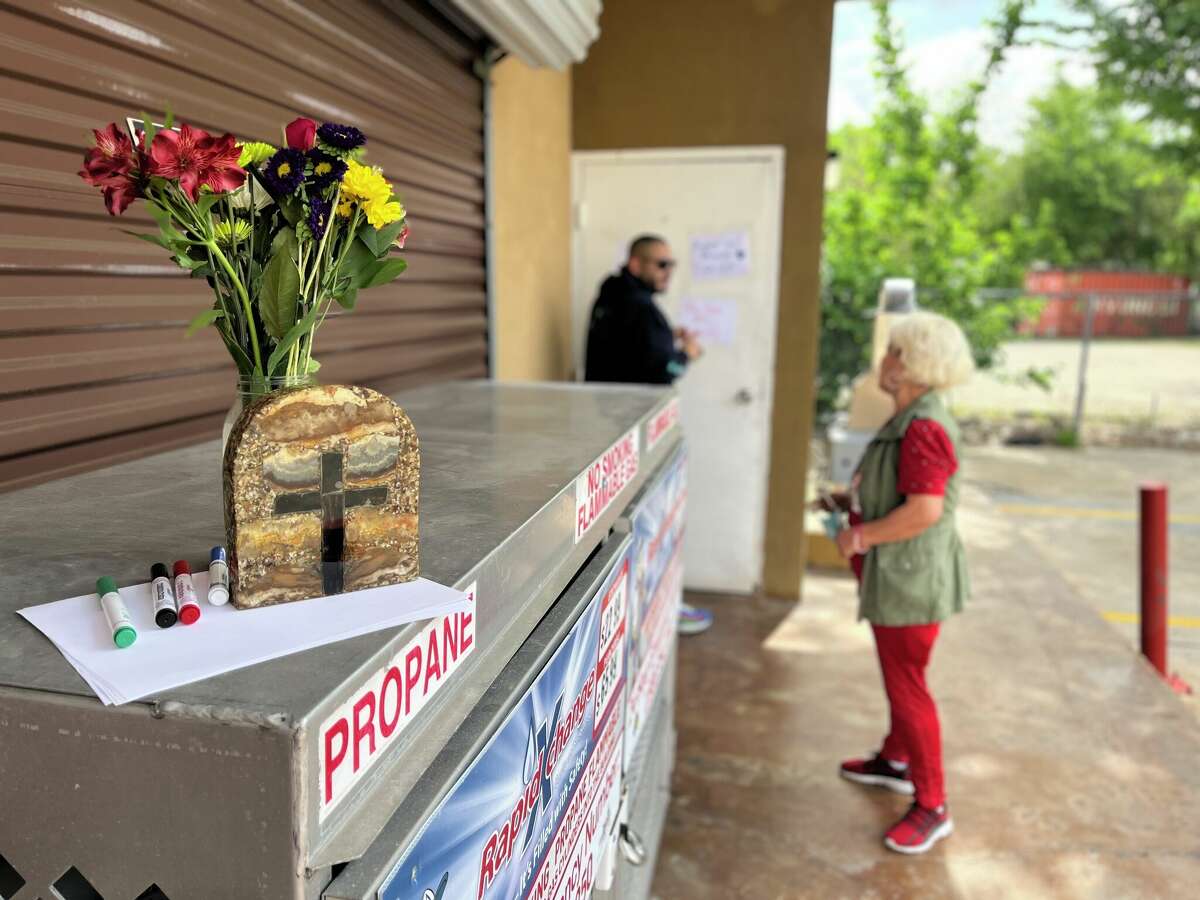 Michael Rodriguez and Amalia Barnetla pay their respects on April 24, 2022, to Carlos, a gas station clerk who was killed on April 23, 2022, while working at the Conoco gas station at 4620 N. Main.