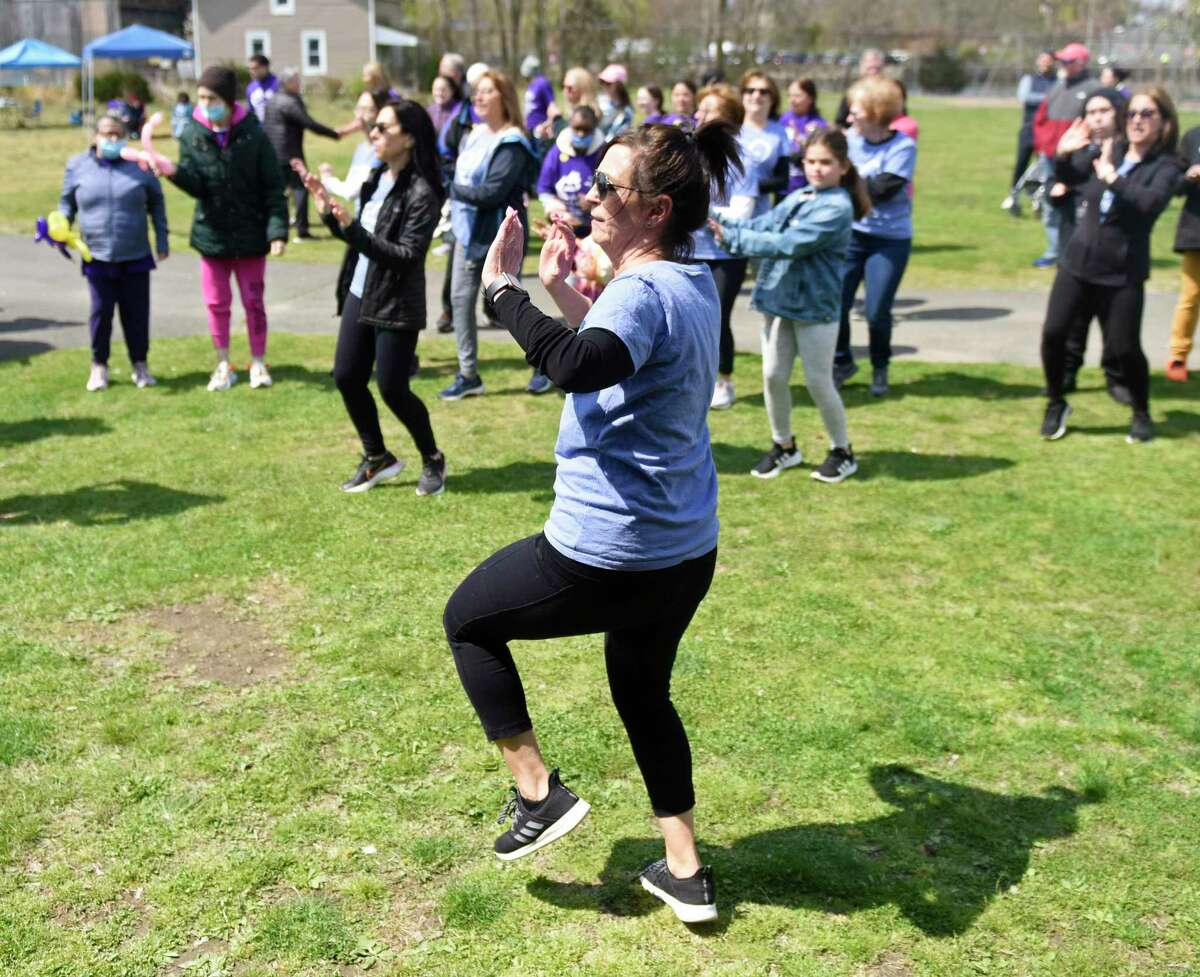 Eleanor Casale, of Dance with El, warms up participants before the 16th annual ARI Walk for Independence at Cove Island Park in Stamford, Conn. Sunday, April 24, 2022. Hundreds of folks attended the walk, which serves as a fundraiser to benefit those with disabilities through employment services, housing, recreation, and clinical care. Dance With El the Ha Ha Gang clowns from Stamford Hospital were on hand to entertain before the walk.