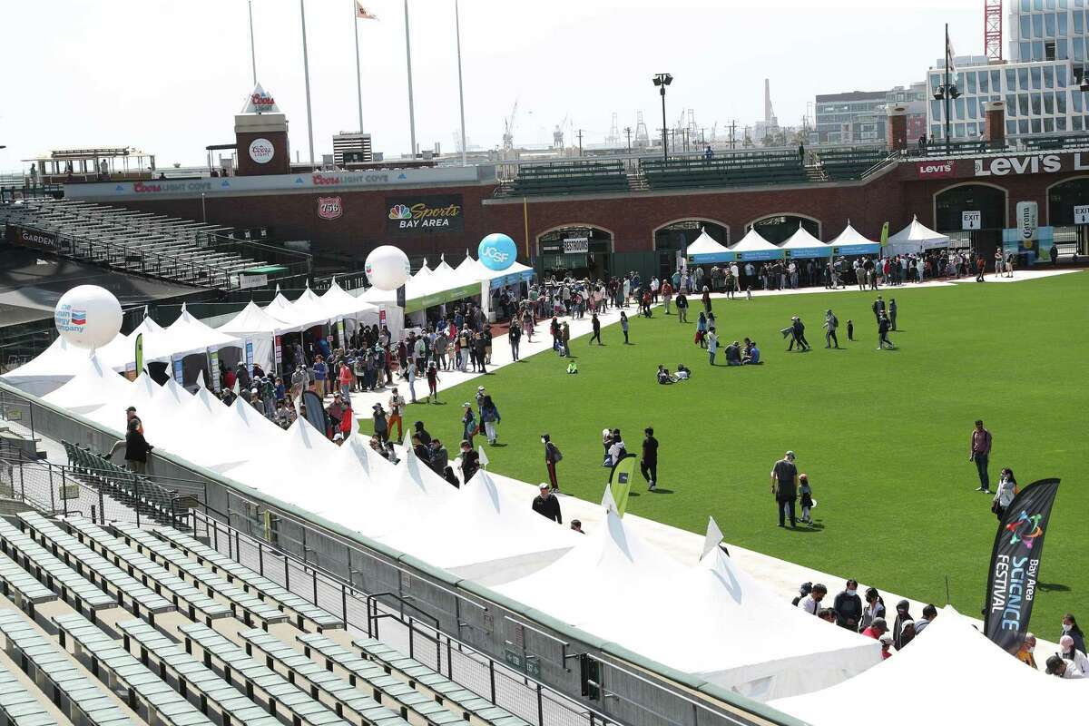 Booths line the outfield warning track during Bay Area Science Festival at Oracle Park in San Francisco.