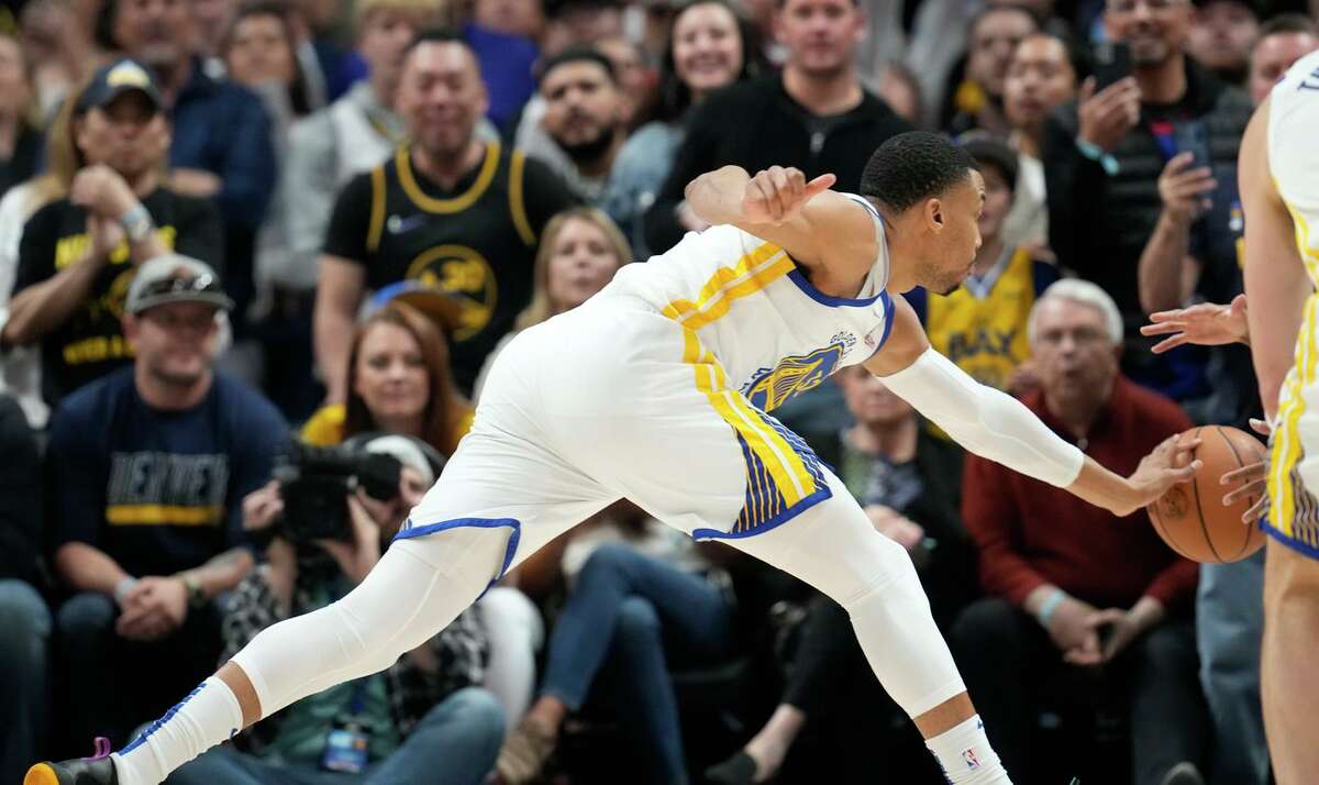 Golden State Warriors forward Otto Porter Jr. pursues the ball as it bounds out of play after being lost on an in-bounds pass late in the second half of Game 4 of an NBA basketball first-round Western Conference playoff series against the Denver Nuggets, Sunday, April 24, 2022, in Denver.