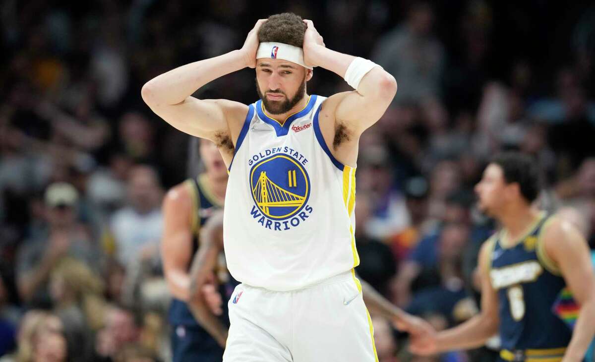 Golden State Warriors guard Klay Thompson reacts after getting hit on the head by a pass in the second half of Game 4 of an NBA basketball first-round Western Conference playoff series against the Denver Nuggets, Sunday, April 24, 2022, in Denver.
