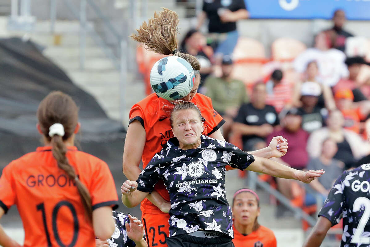 Racing Louisville FC midfielder Lauren Milliet, front, and Houston Dash defender Katie Naughton, back, collide as they both go for a header during the first half of a NWSL Challenge Cup soccer game Sunday, Apr. 24, 2022 at PNC Stadium in Houston, TX.
