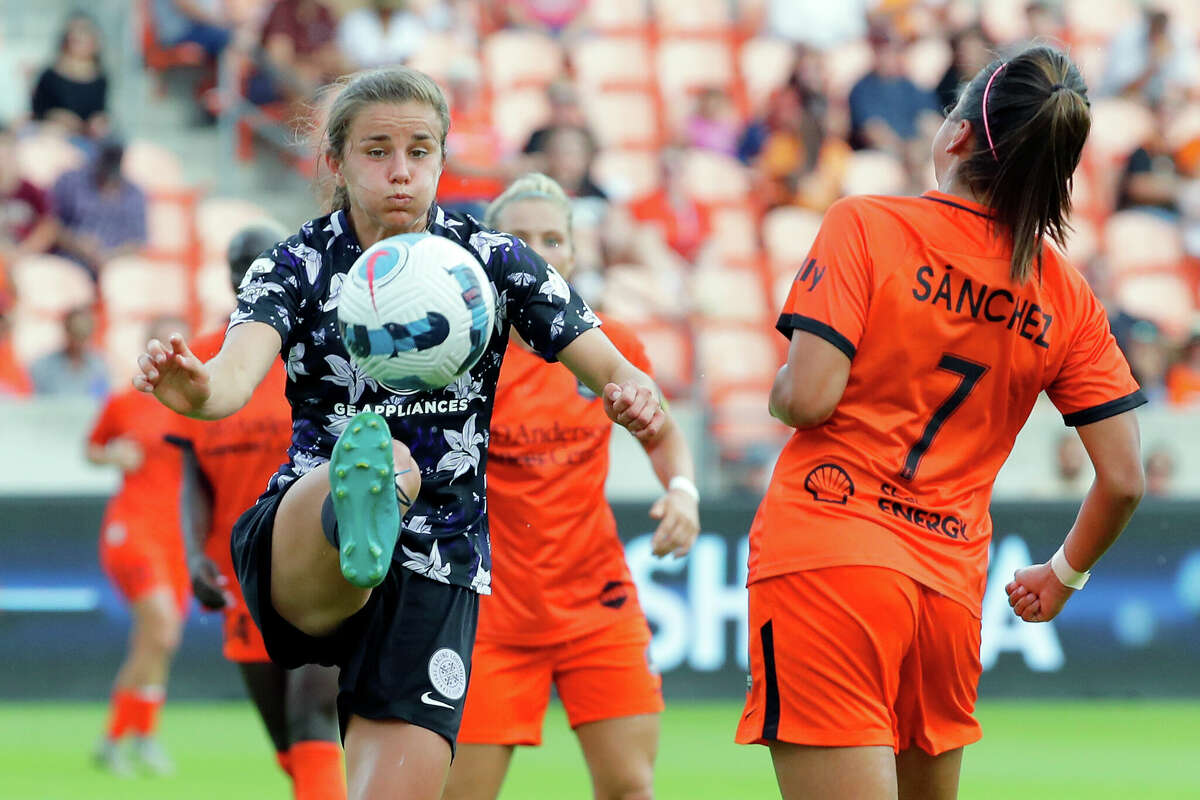 Racing Louisville FC defender Nealy Martin, left, kicks the ball away next to Houston Dash forward Maria Sanchez (7) during the first half of a NWSL Challenge Cup soccer game Sunday, Apr. 24, 2022 at PNC Stadium in Houston, TX.