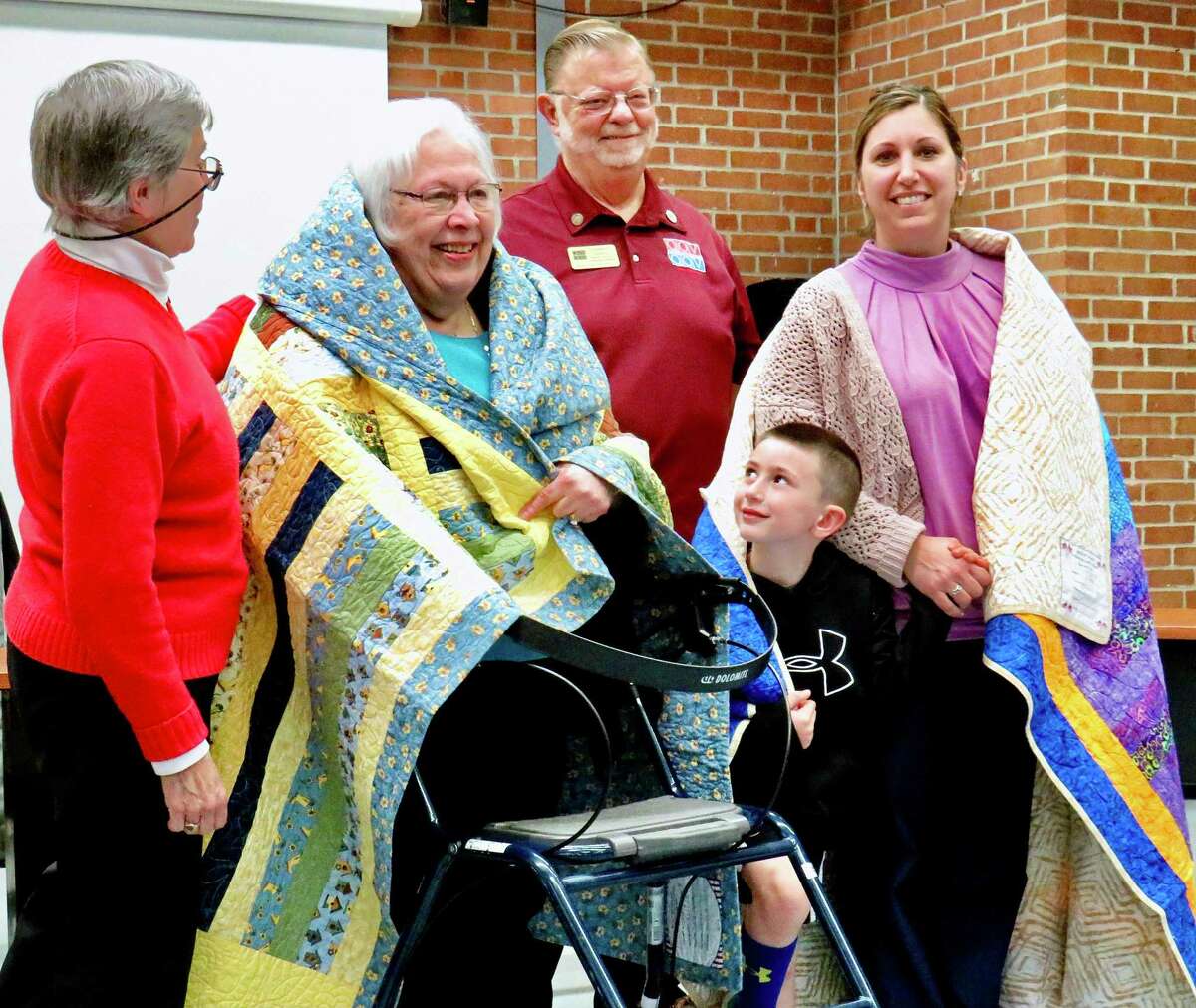 Janet Dougherty of the Quilts of Valor Foundation, with honoree Janet Schmitt, a veteran of the Air Force who served in the Vietnam era; the Quilt of Valor Foundation’s Chuck Larkins; Charleen Fischer, senior master sergeant in the CT Air National Guard; and her son James