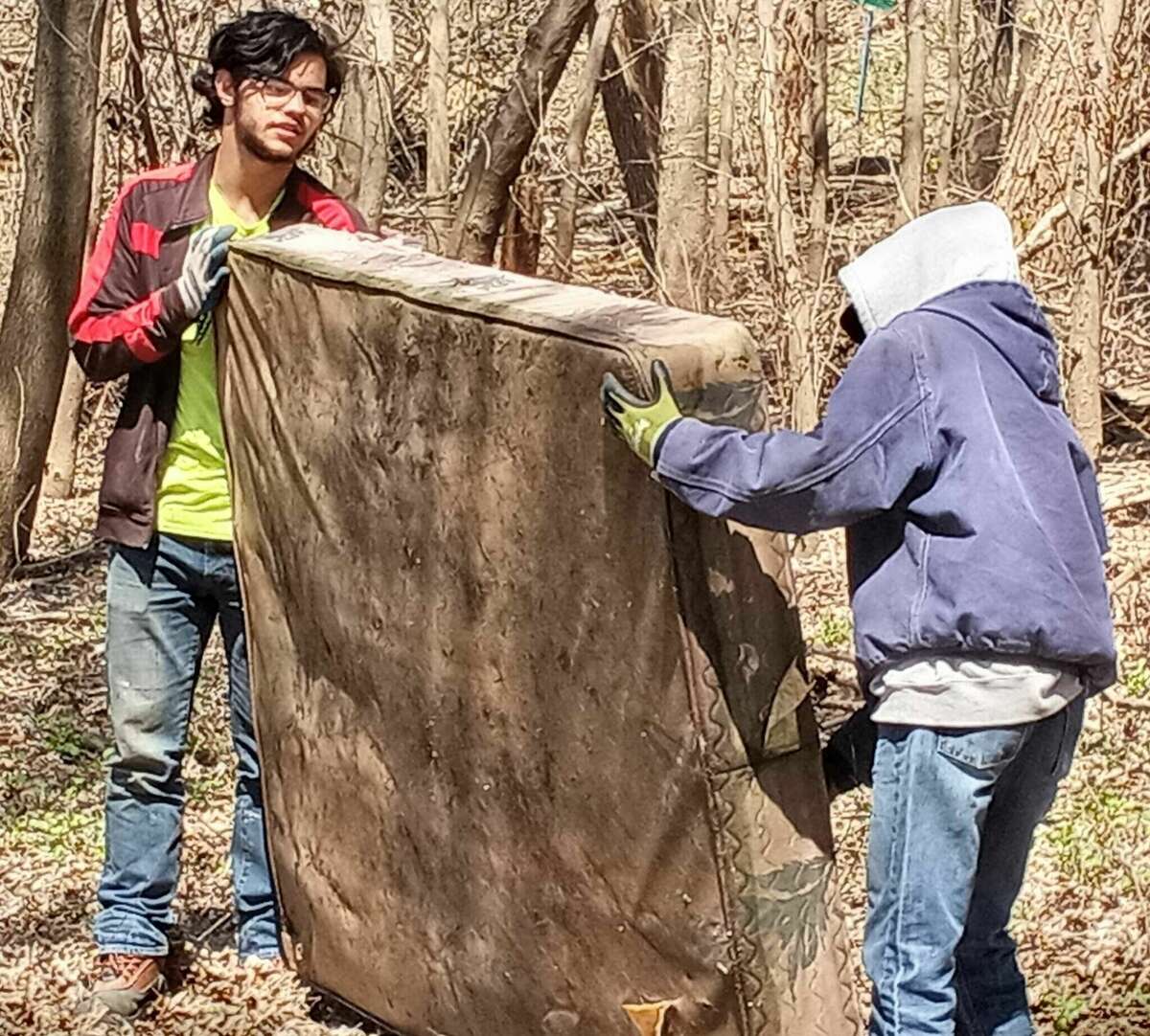 Students remove an old mattress during a Living Lands & Waters cleanup near the Mississippi River on April 14. The group will host another cleanup from 9 a.m.-noon Wednesday, April 27. 