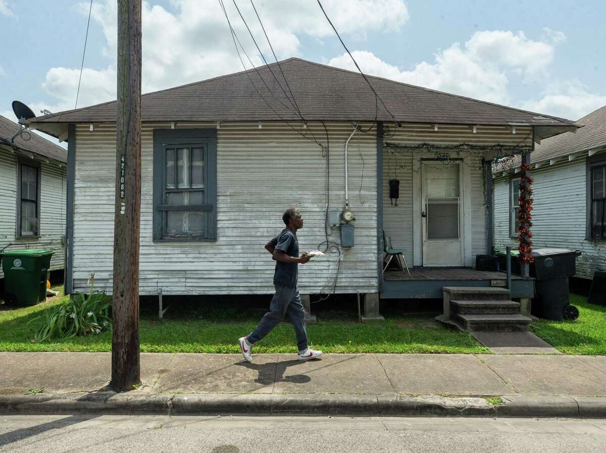 Donald Edwards, 69, walks back to his home with a plate of lunch on Thursday, April 21, 2022, in Fifth Ward. Edwards lives in one of the homes Fifth Ward CRC recently bought with plans to rent to local artists as part of its increased focus on affordable rentals to prevent displacement. The organization says current residents will have the option to stay if they chose to do so.