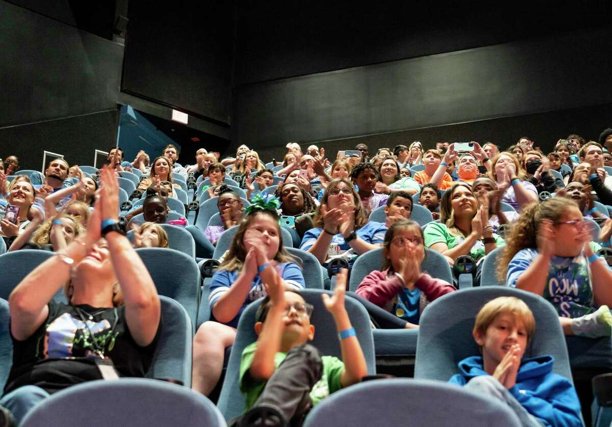 Students, teachers and chaperones applaud from the auditorium of Space Center Houston as they talk with members of the Axiom Space crew at their temporary home on the International Space Station Wednesday, April 13, 2022, in Houston. Students ranging from elementary school students to high schoolers from around the state were able to ask pre-written questions to the crew members.