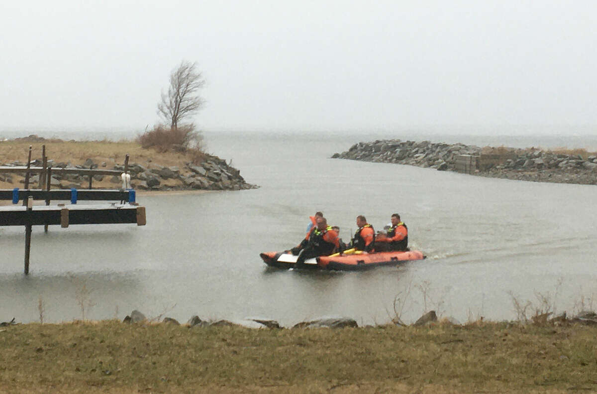 Members of the Port Austin Fire Department transport three rescued kayakers back to shore Sunday afternoon as a thunderstorm moved into the region.