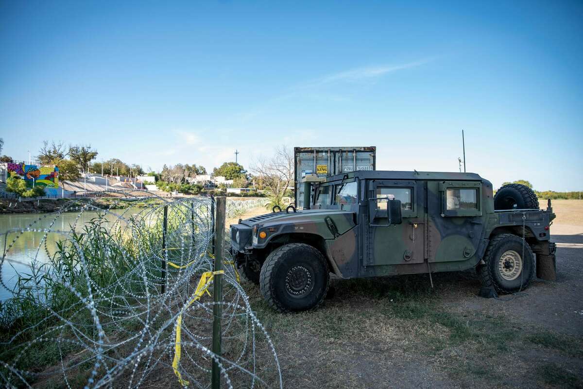 Shipping containers and High Mobility Multipurpose Wheeled Vehicle (HMMWV, aka Humvee) military vehicles line the area near the Rio Grande river on November 19, 2021 in Eagle Pass, Texas.