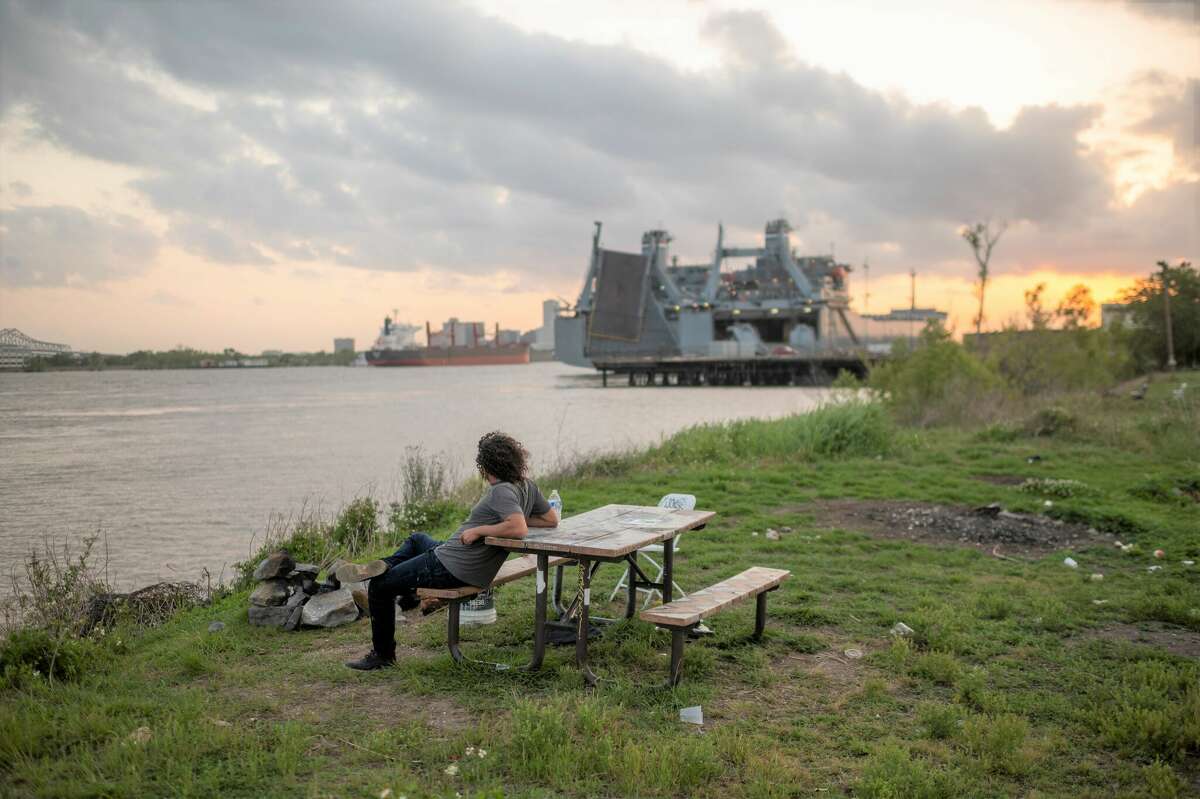 A man sits on a picnic table at "The End of the World", an unofficial park in New Orleans' Bywater neighborhood.