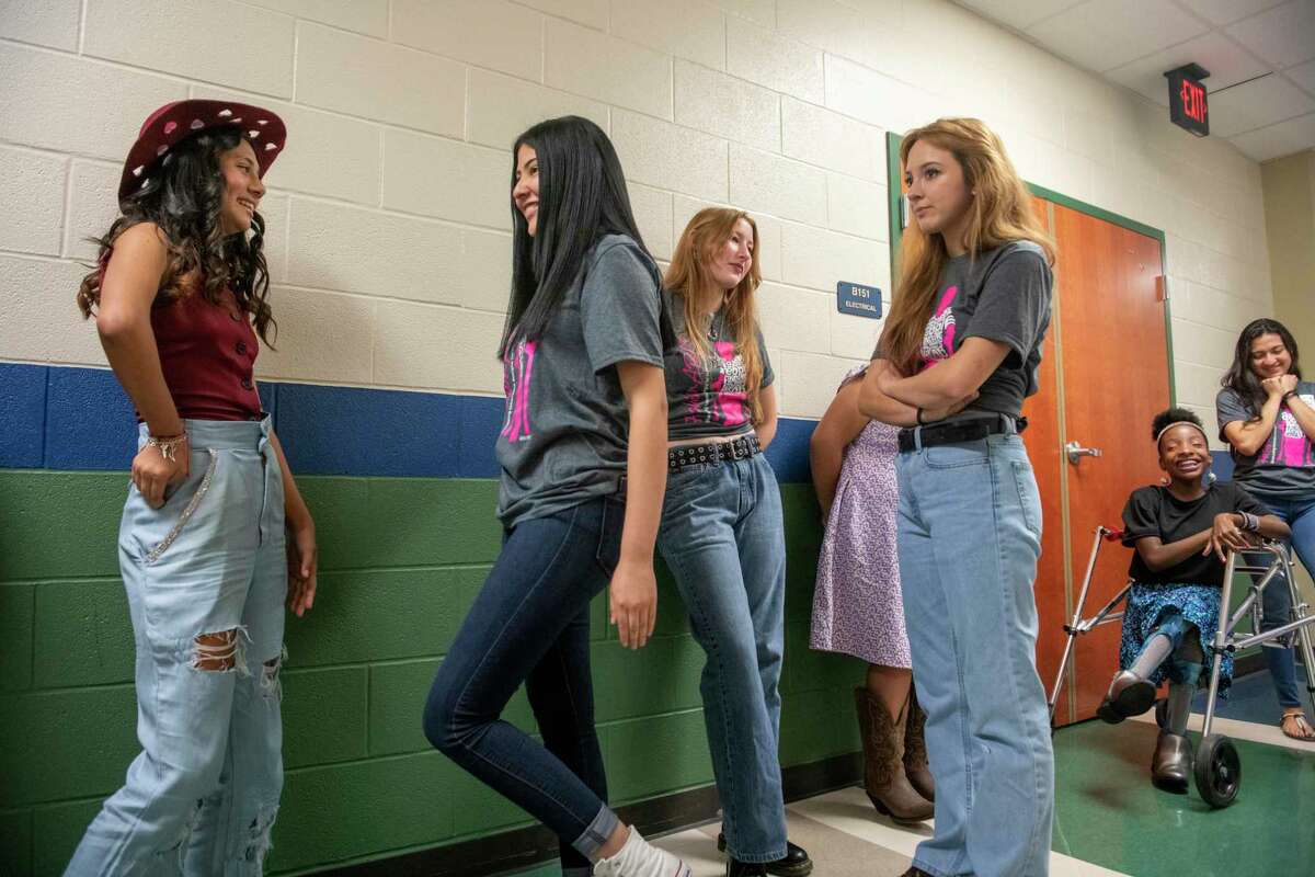 Ariana Gutierrez, 12, who has erb's palsy, left, and Amberlyn Reyna-Martinez, 17,right, a design student at Wagner High School, await their turn backstage at Stevens High School auditorium during Fashion Able, a fashion show where children with spina bifida and other disabilities will model garments created with fashion design students from six local high schools on Saturday, April 23, 2022. The pair collaborated on designing a crop top and ripped mom jeans that Martinez tailored and altered for Ariana's comfort.