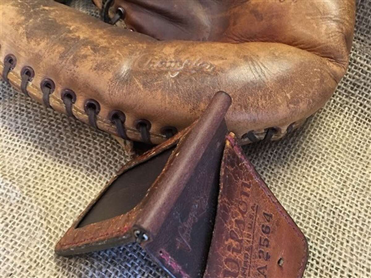 Old baseball gloves and footballs are taken apart, cleaned, conditioned and hand stitched into unique wallets or other leather products.