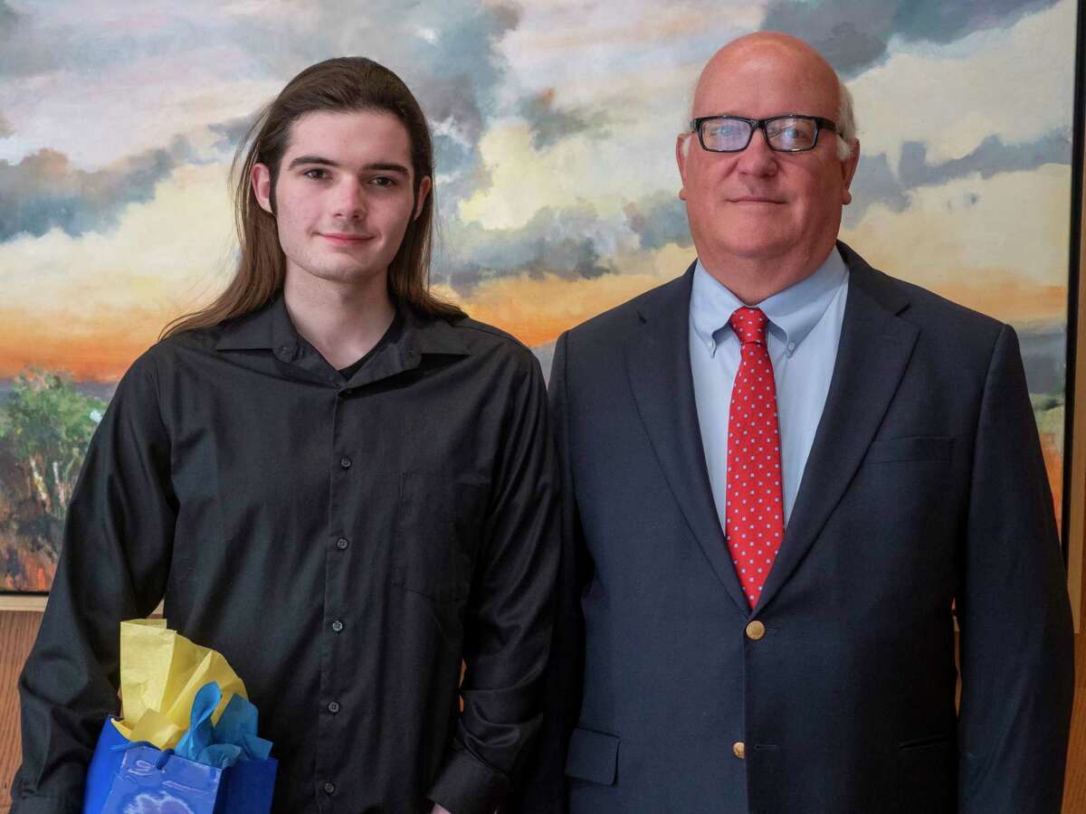 Todd Westmorelind, President of Exchange Club of Midland, presents Midland High outstanding English student, Zayne Calley with an award during the annual Exchange Club of Midland Awards luncheon 04/25/2020 honoring top seniors at the Petroleum Club. Tim Fischer/Reporter-Telegram