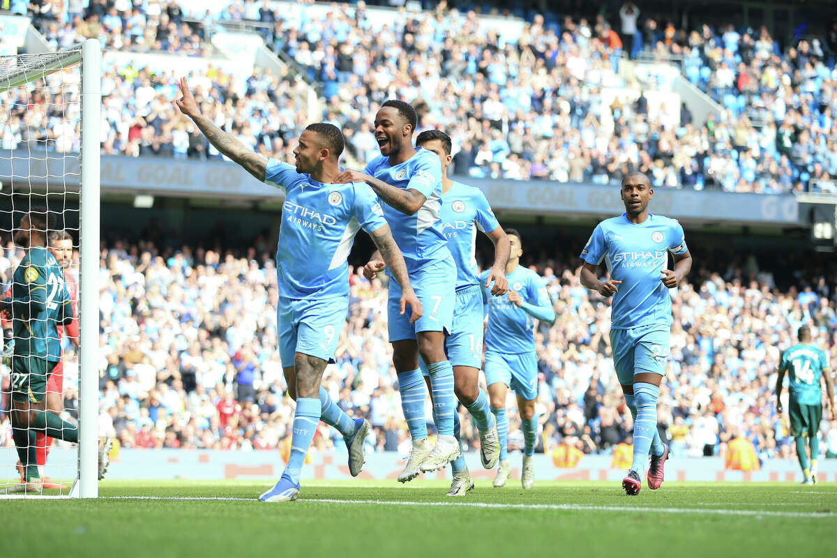 Gabriel Jesus of Manchester City (left) celebrates with Raheem Sterling of Manchester City after scoring their 4th goal during the Premier League match between Manchester City and Watford at Etihad Stadium on April 23, 2022 in Manchester, United Kingdom.