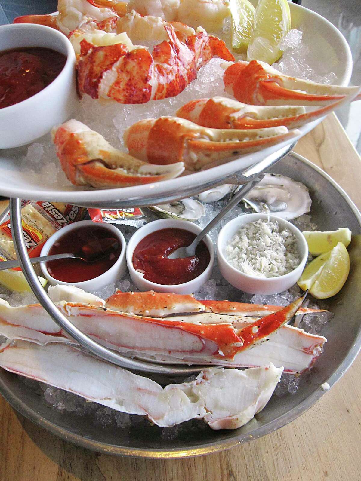 A large chilled seafood tower includes lobster, shrimp, crab claws, oysters and king crab legs at Silo Terrace Oyster Bar.