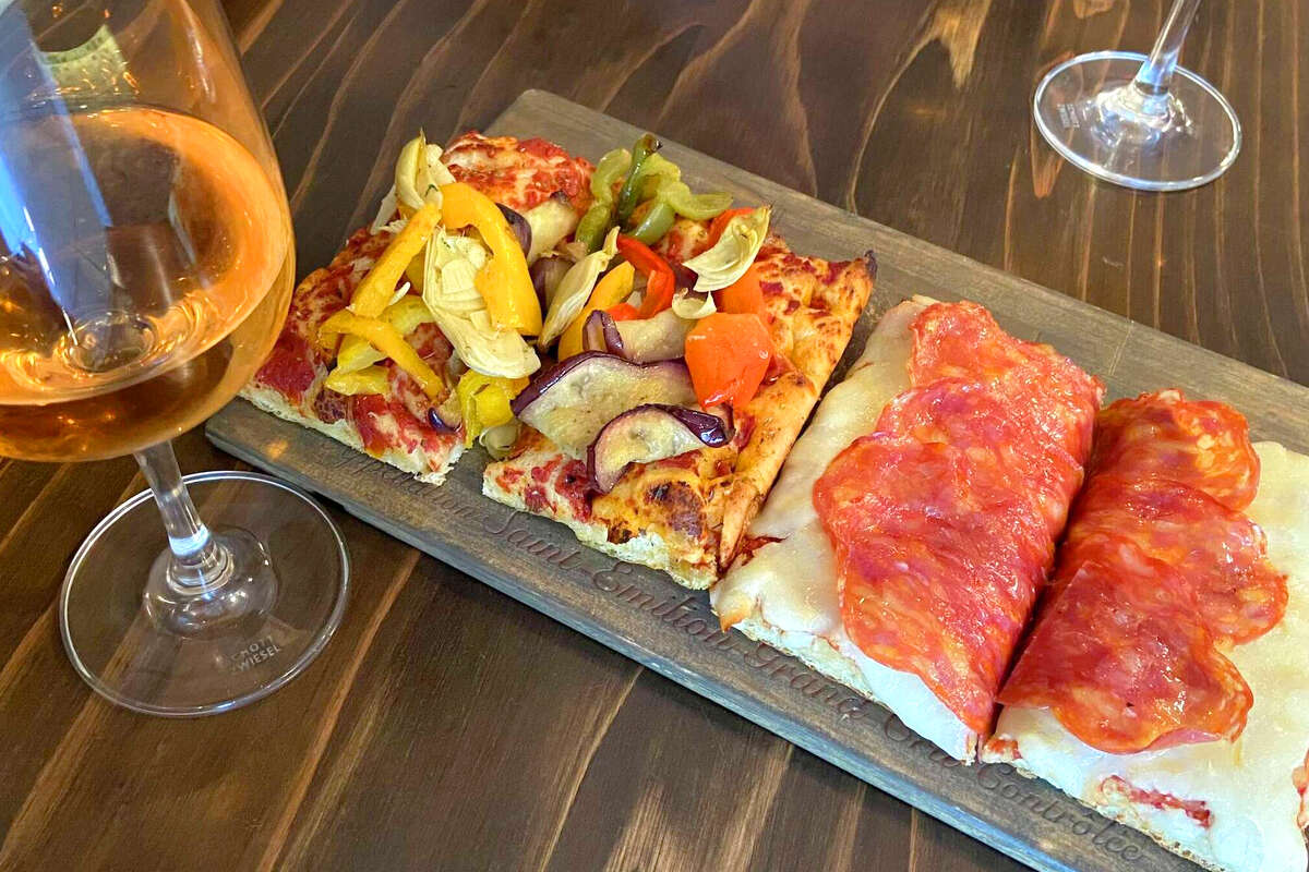 Casa Barotti's pizza al trancio pairs best with wine during happy hour, and each slice ranges from $5 to $7.