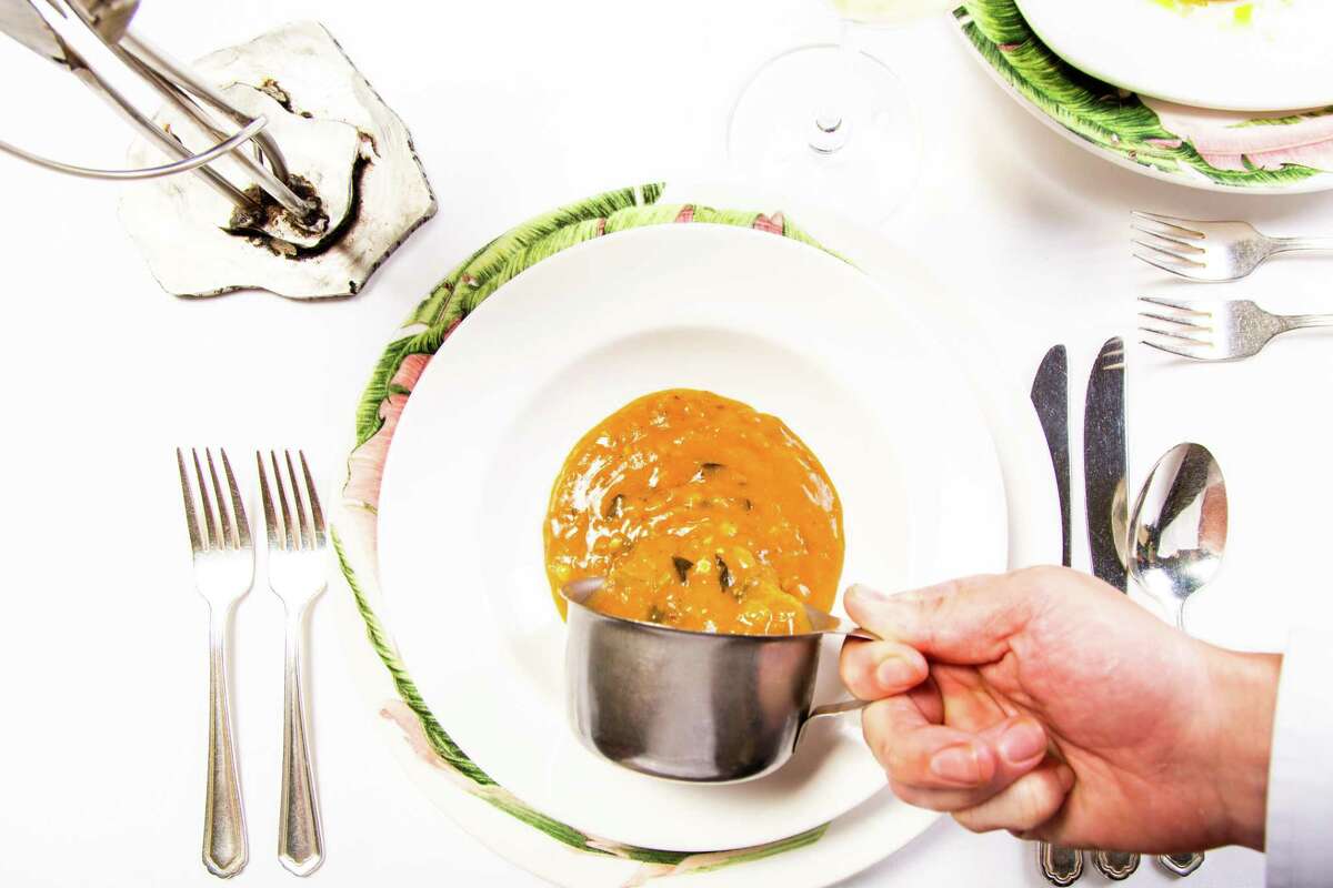 Haute Creole dishes are beloved menu items at Commander's Palace in New Orleans, including the classic turtle soup, finished tableside with a splash of aged sherry.