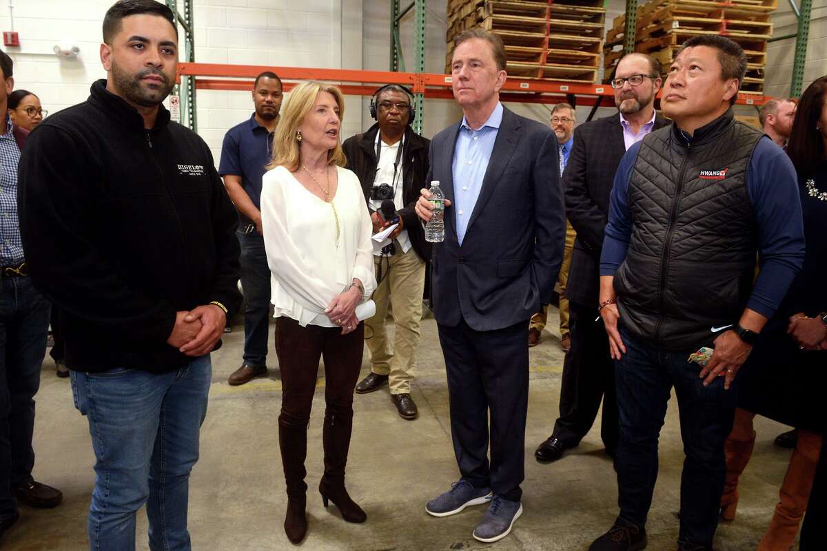 President and CEO Cindi Bigelow speaks with Gov. Ned Lamont during his visit to Bigelow Tea headquarters, in Fairfield, Conn. April 25, 2022.