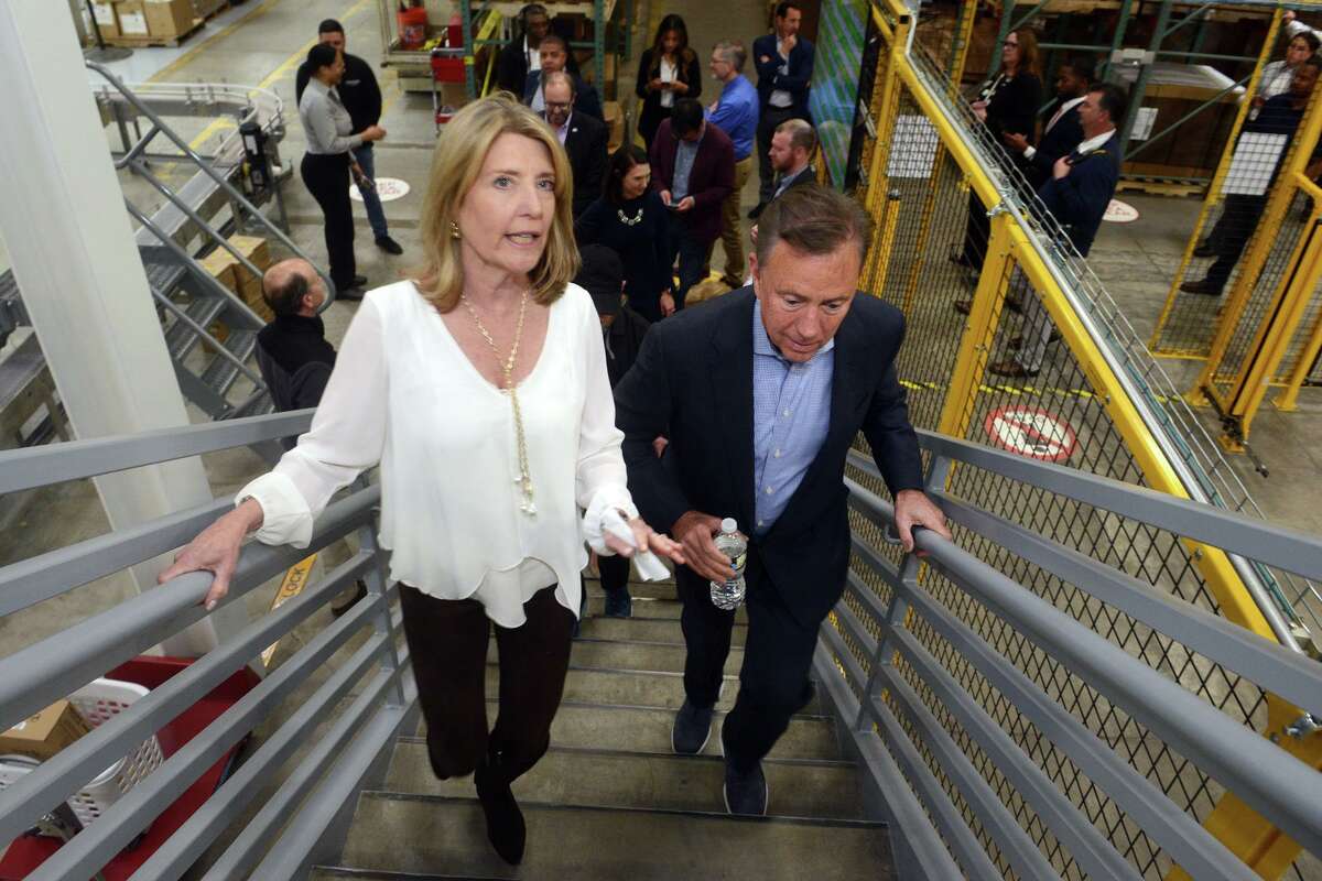 President and CEO Cindi Bigelow walks with Gov. Ned Lamont during his visit to Bigelow Tea headquarters in Fairfield on Monday.