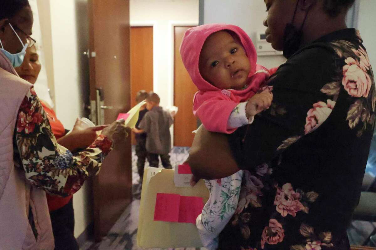 Holding her three-month-old daughter, a Honduran migrant gets help from Catholic Charities San Antonio at a hotel. The nonprofit helps migrants with lodging, food, clothing and if needed traveling fares. They also provide legal help when needed.