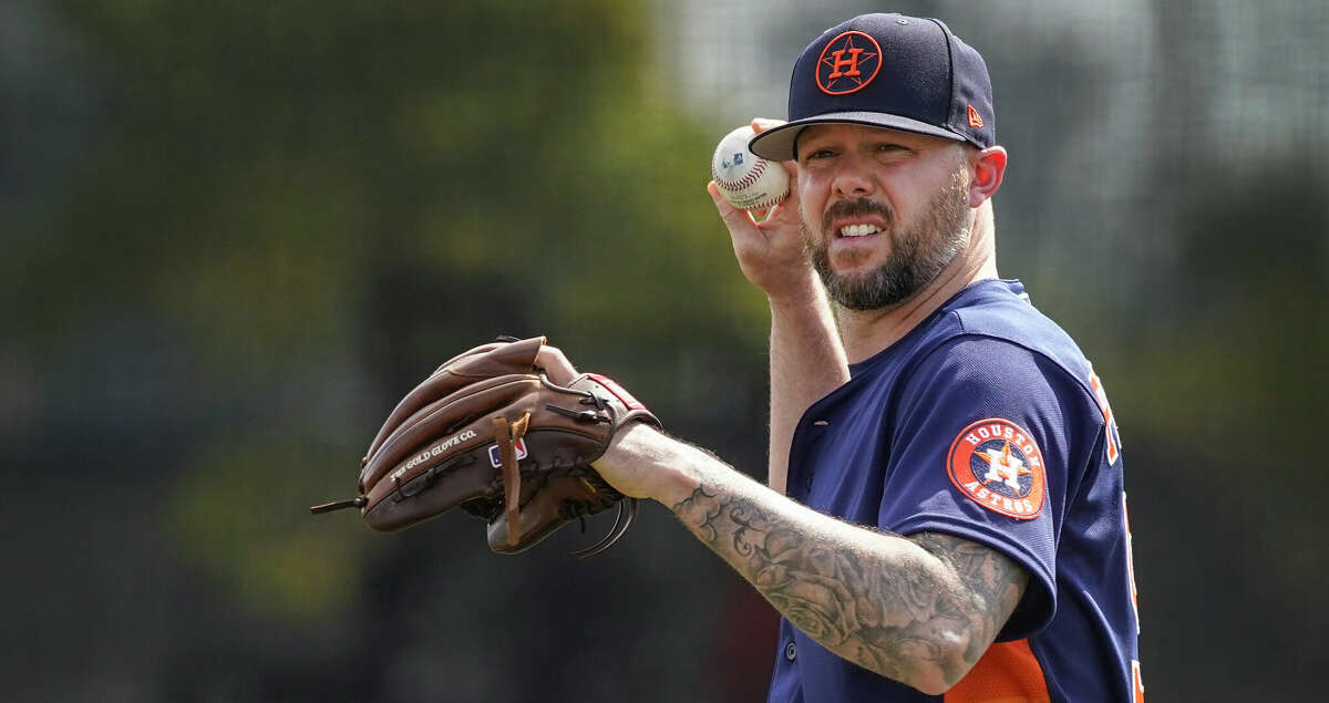 Houston Astros pitcher Ryan Pressly warms up before throwing during work outs at the Astros spring training camp at The Ballpark of the Palm Beaches on Thursday, March 17, 2022 in West Palm Beach .