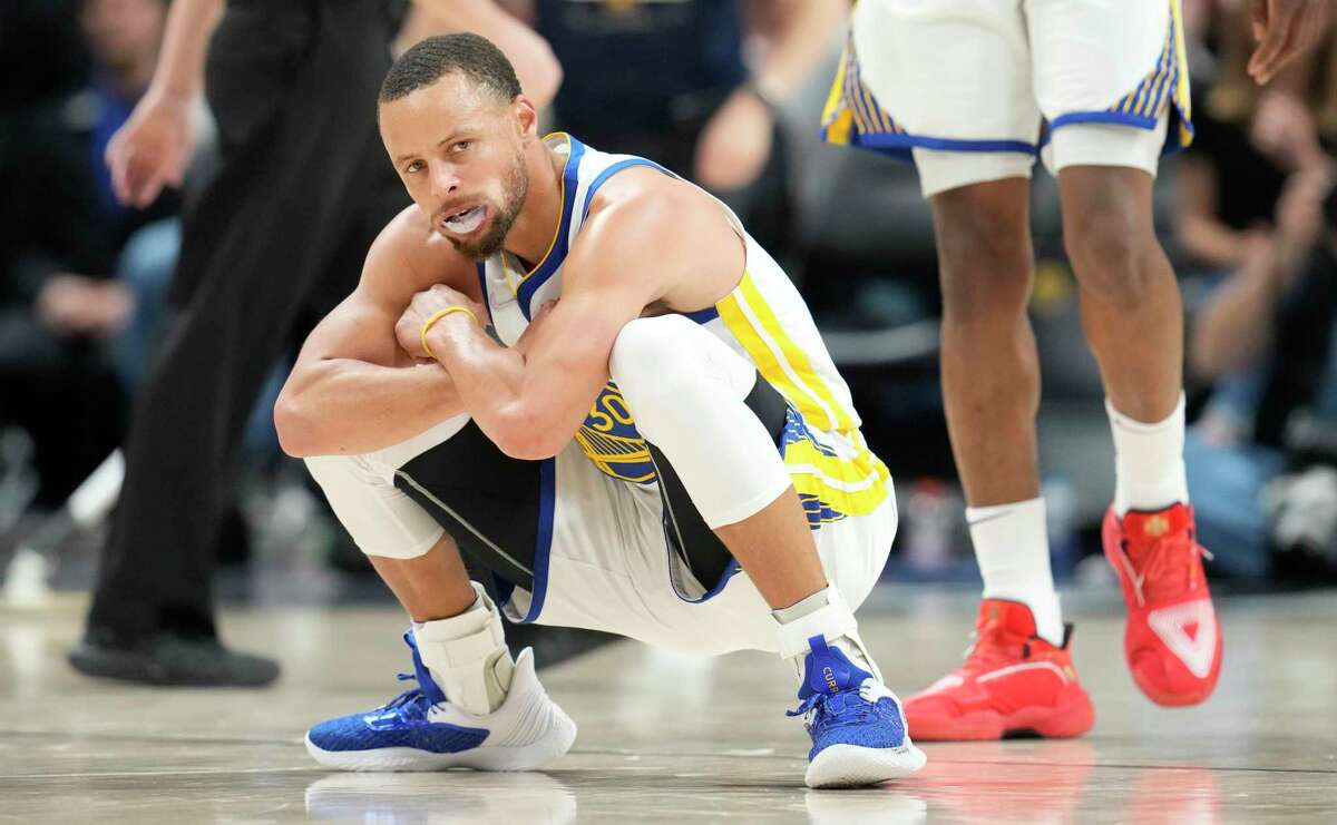 Golden State Warriors guard Stephen Curry reacts after hitting a 3-point-basket in the second half of Game 4 of an NBA basketball first-round Western Conference playoff series against the Denver Nuggets, Sunday, April 24, 2022, in Denver. (AP Photo/David Zalubowski)