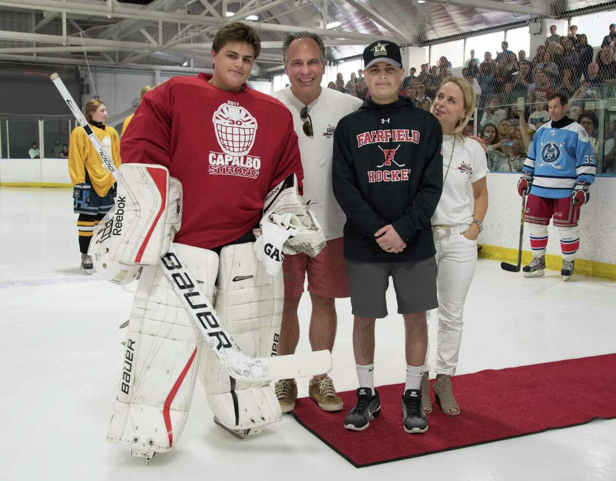Charlie Capalbo, second from right, and his family at a hockey jamboree in his honor at Wonderland of Ice in Bridgeport. Capalbo, whose battle with cancer inspired the hockey community in Connecticut and beyond, died Sunday at age 23.