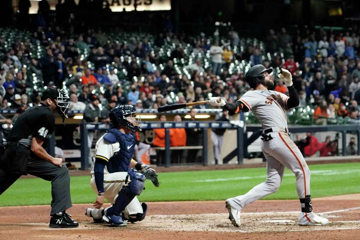 San Francisco Giants' Luis Gonzalez hits a two-run home run during the ninth inning of a baseball game against the Milwaukee Brewers Monday, April 25, 2022, in Milwaukee. (AP Photo/Morry Gash)