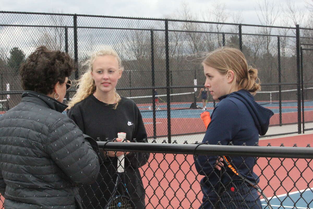 Big Rapids tennis coach Renee Kent (left) confers with Kara Paquette (center) and Cortney Myers at No. 1 doubles during their match with Mount Pleasant on Monday.