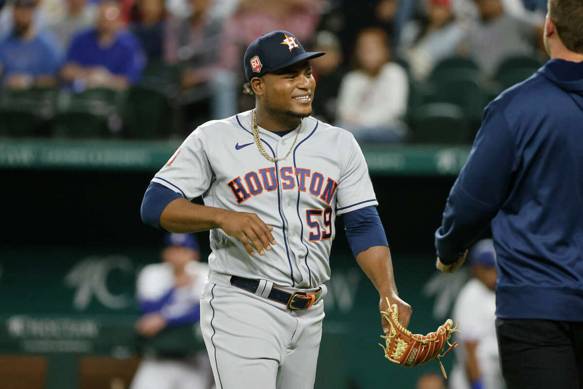 Houston Astros starting pitcher Framber Valdez (59) reacts after he was hit by part of a broken bat while playing the Texas Rangers during the fourth inning of a baseball game Monday, April 25, 2022, in Arlington, Texas. (AP Photo/Michael Ainsworth)