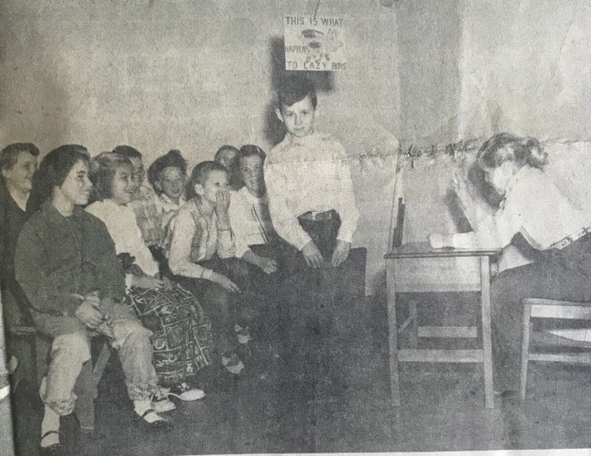 Fourth graders at Eastlawn School depict a scene from the book, "Old Fashioned School." Gene LaClair, standing, and Linda Griffin, seated at right, participate. December 1956