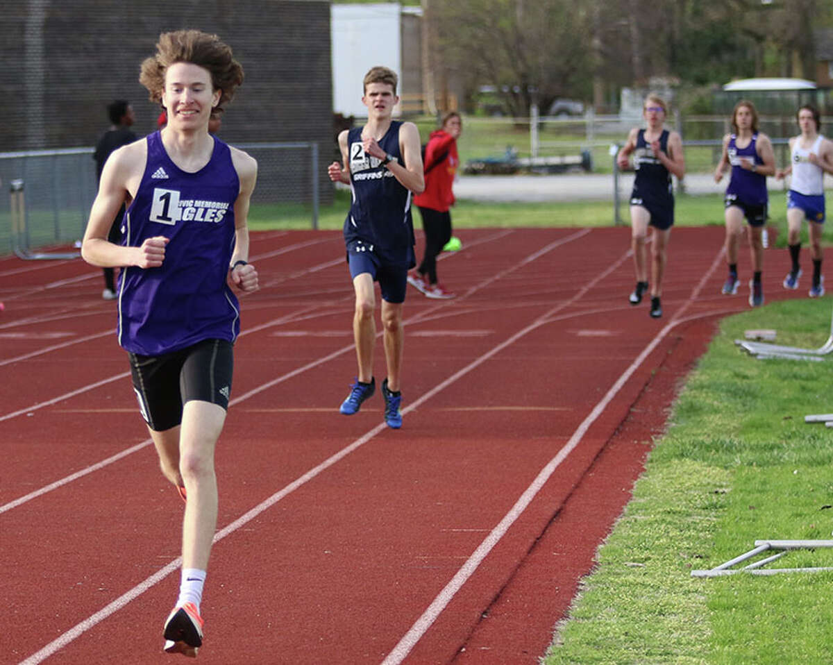 CM's Lucas Naugle (left) enjoys his first of eight laps in the 3,200 meters at the Madison County small-schools boys track meet on Monday at Memorial Stadium in Wood River. Naugle won the race in PR time.