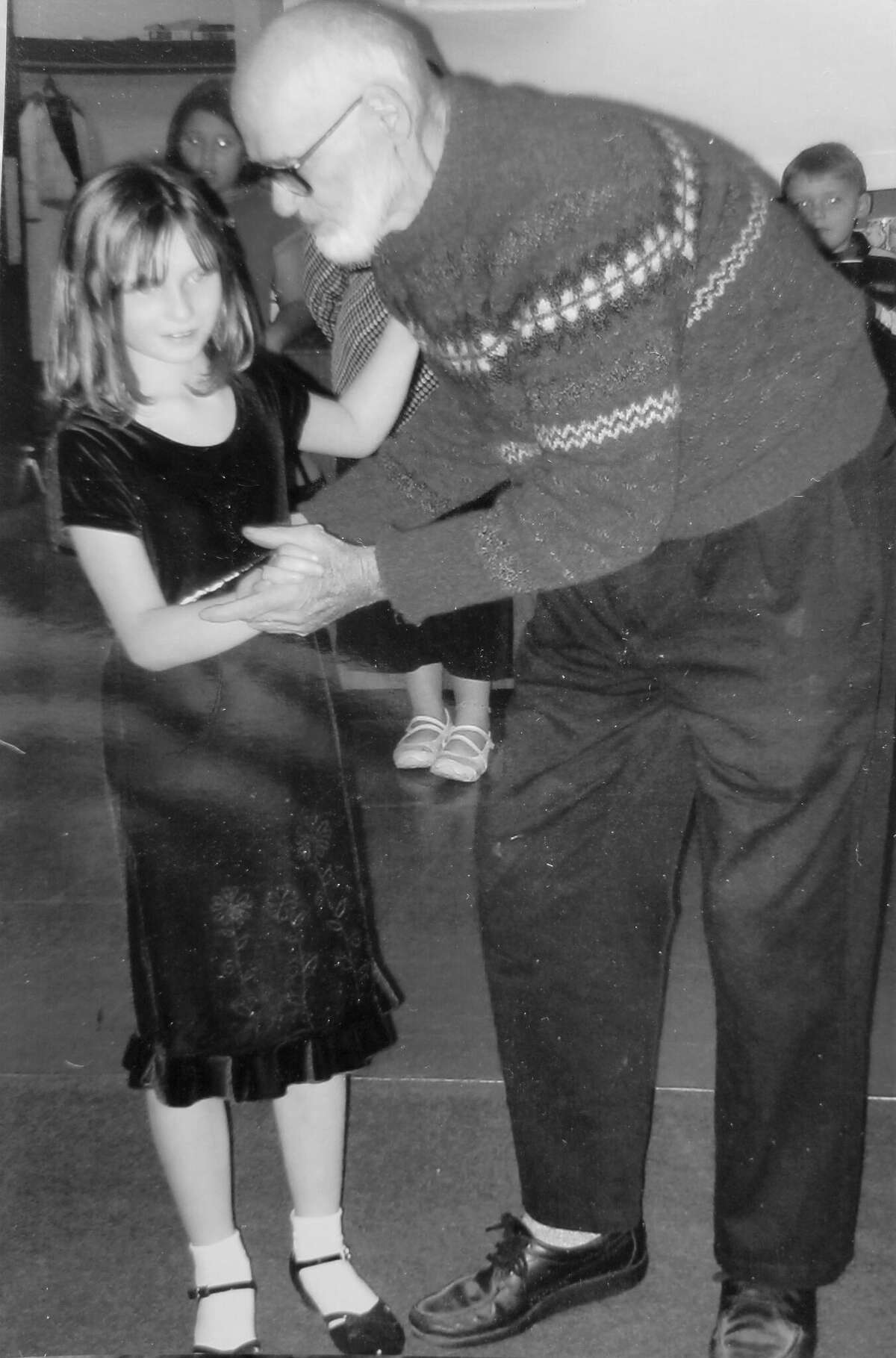 Erwin A. Thompson teaching a youngster to waltz.