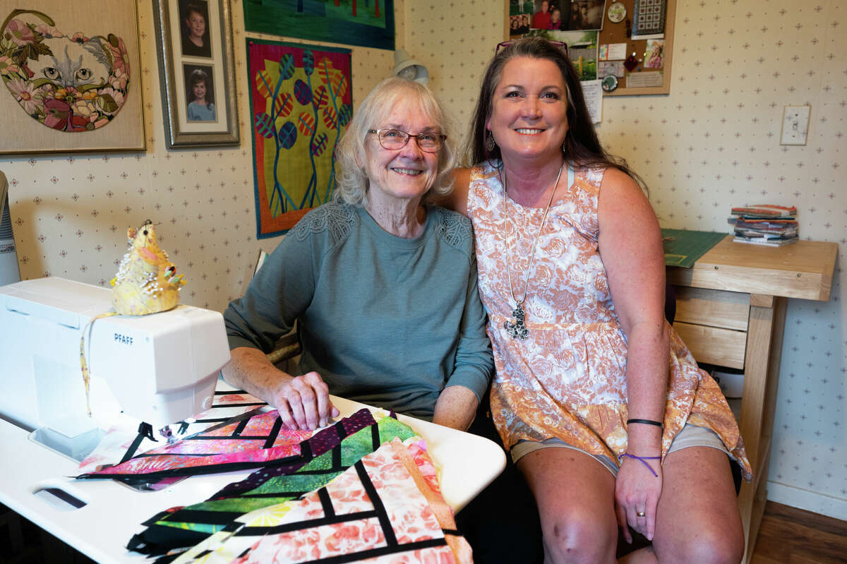 Judy Piper and her daughter Laura Greenfelder pose for a picture at Piper's home in Midland. Piper and Greenfelder are the featured quilters of this year's Midland Quilter's Squared show, April 29-May 1.