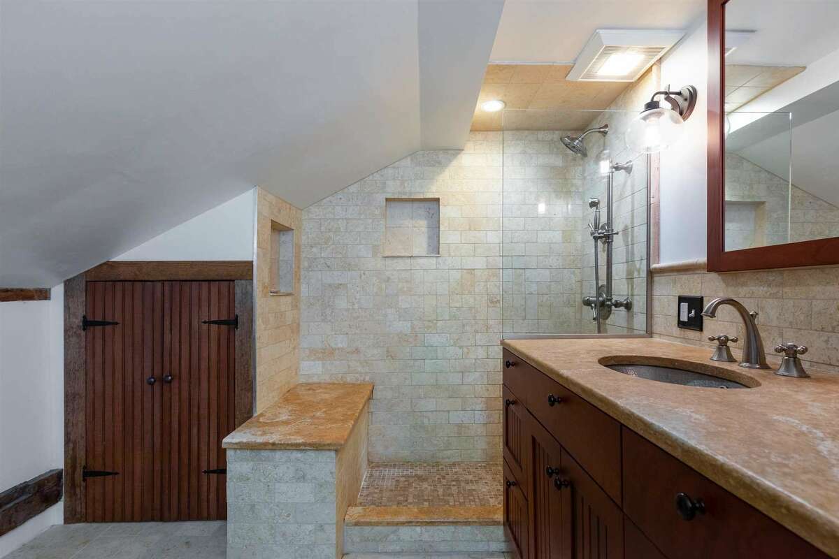 Bathrooms have been updated, including large shower heads in a large tiled walk-in shower.