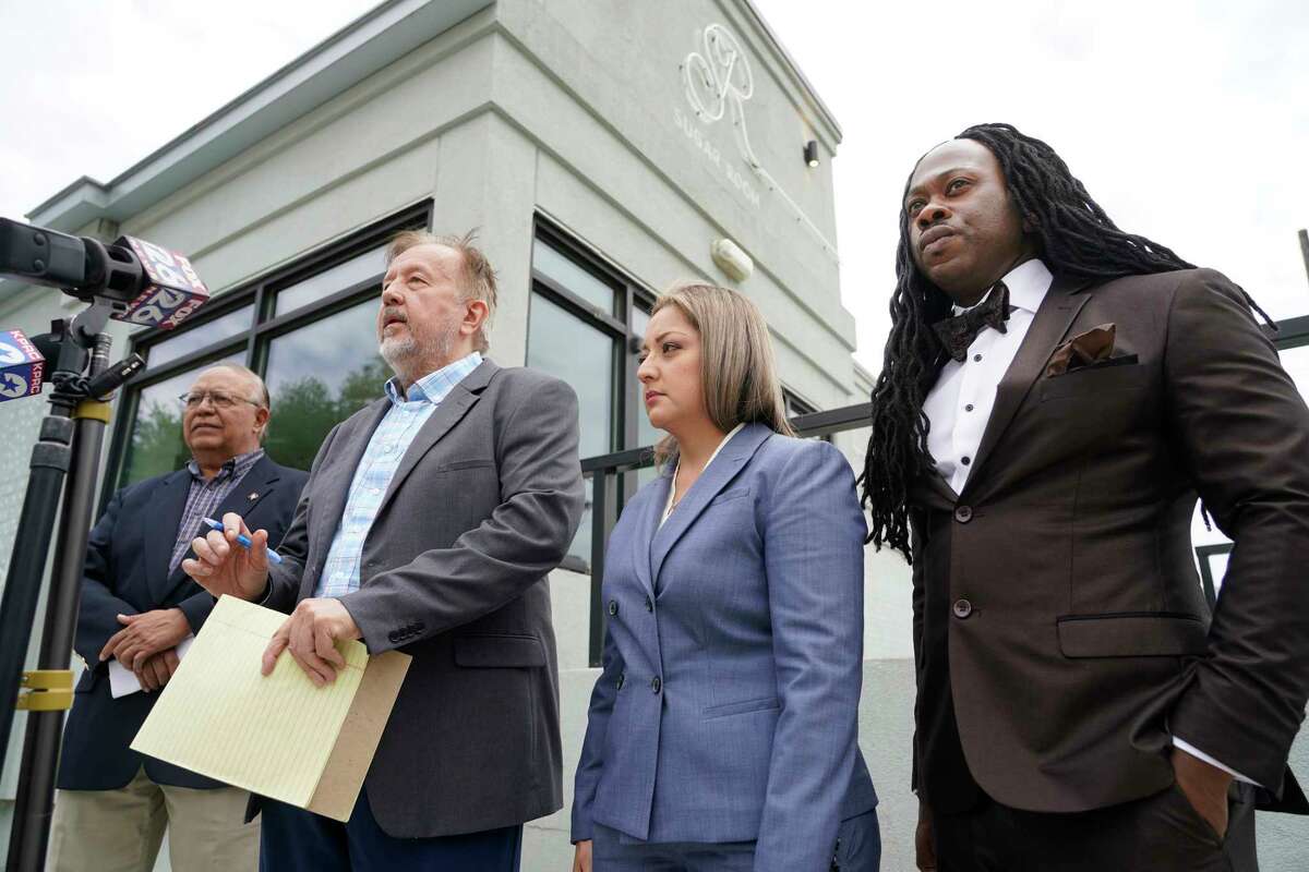 Augie Pinedo, with LULAC, left, Randall Kallinen, civil rights attorney, Cindy Martinez, and William Powells, an attorney, right, are shown during a media conference outside the Sugar Room, 5120 Washington Ave., Tuesday, April 26, 2022, in Houston. Kallinen has filed a federal discrimination lawsuit against the club claiming they denied William Powells entry because he's a Black male. He was at the club to attend a going away party for Cindy Martinez.