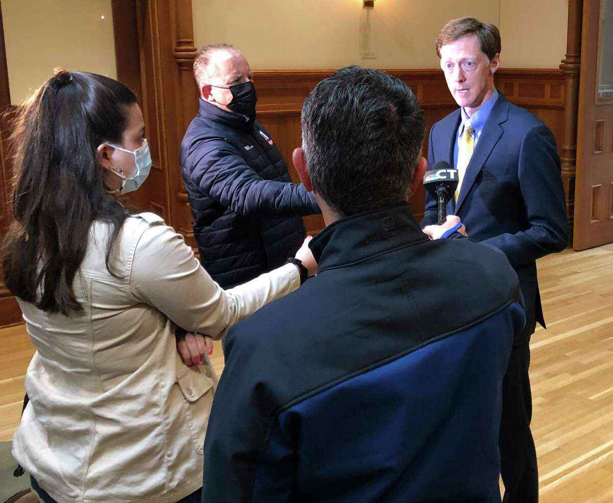 New Haven Mayor Justin Elicker, right, speaks to media about a judge’s order requiring Interim Chief Renee Dominguez to step down.